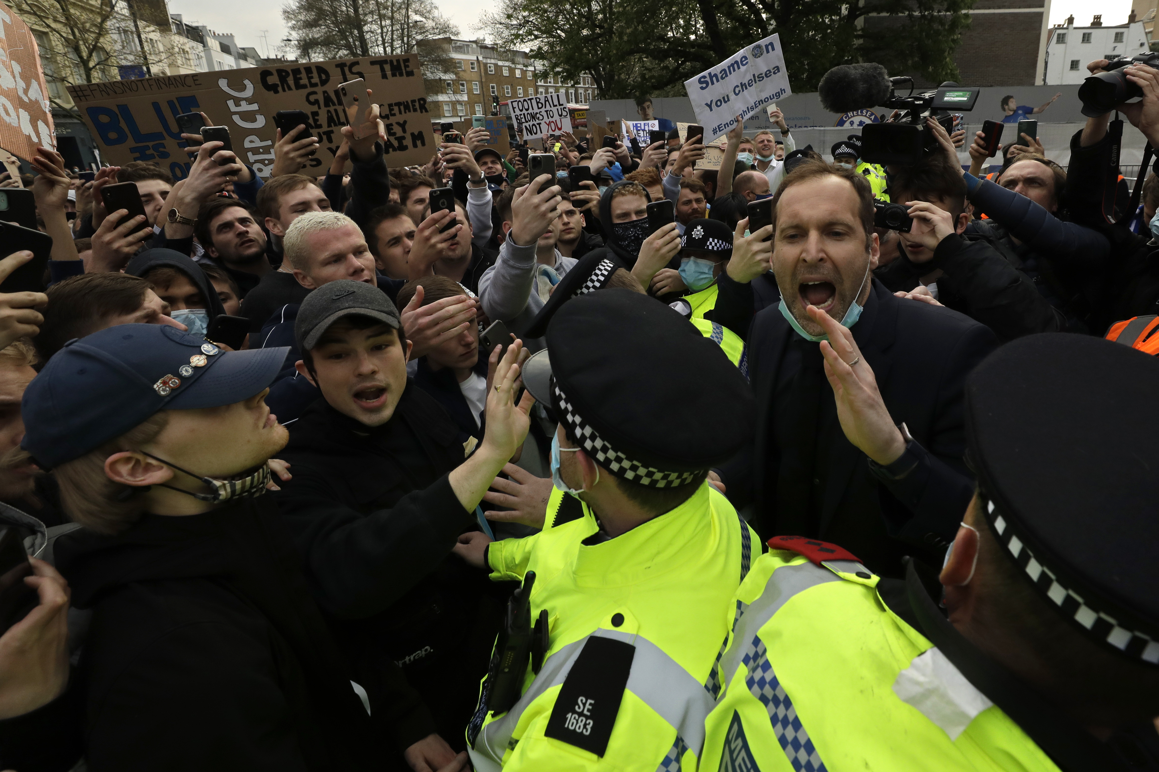 Chelsea's former star goalkeeper Petr Cech, right, tries to calm fans protesting against Chelsea's decision to be included amongst the clubs attempting to form a new European Super League on Tuesday.