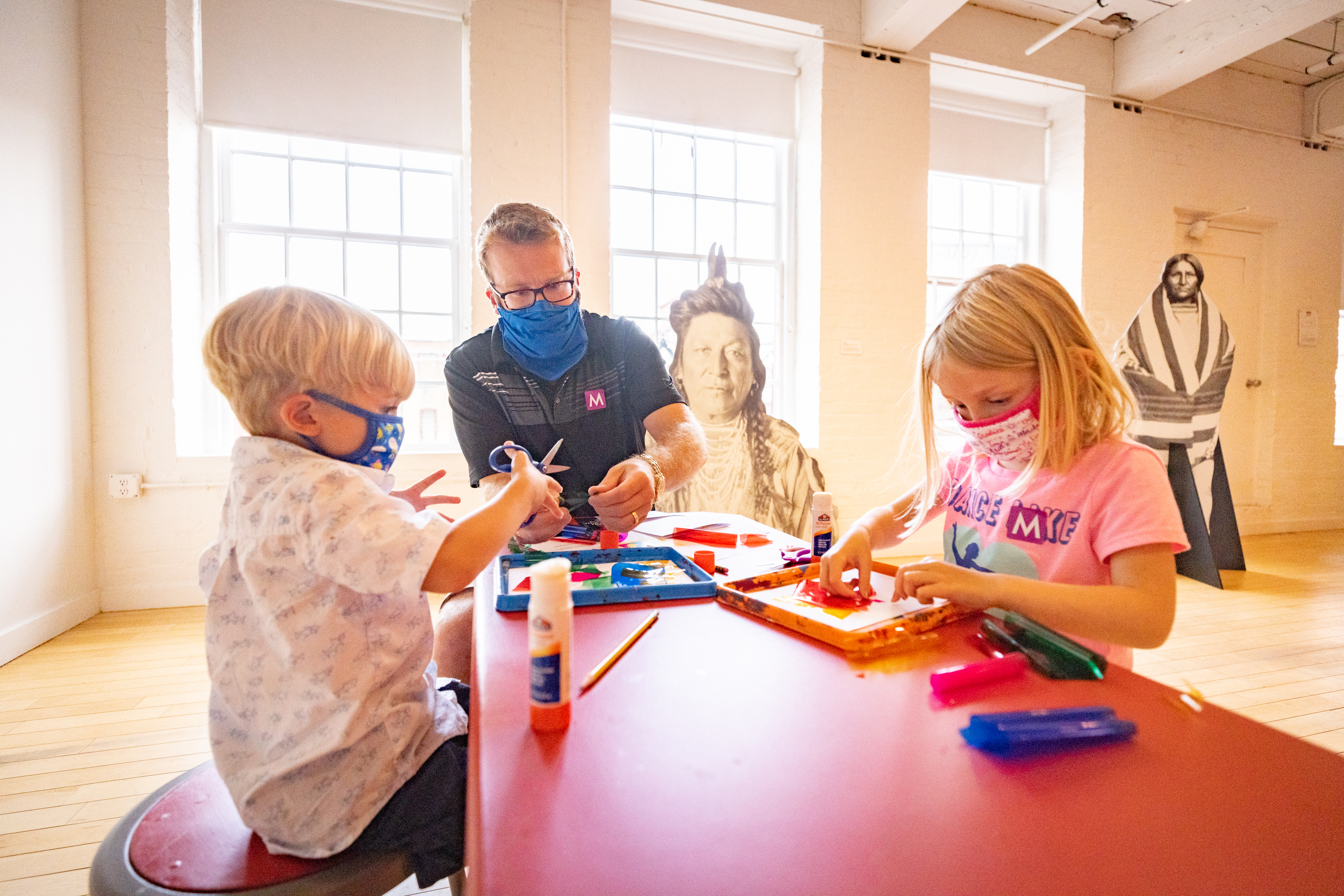 A family worked on an art project during Community Day at Mass MoCA.
