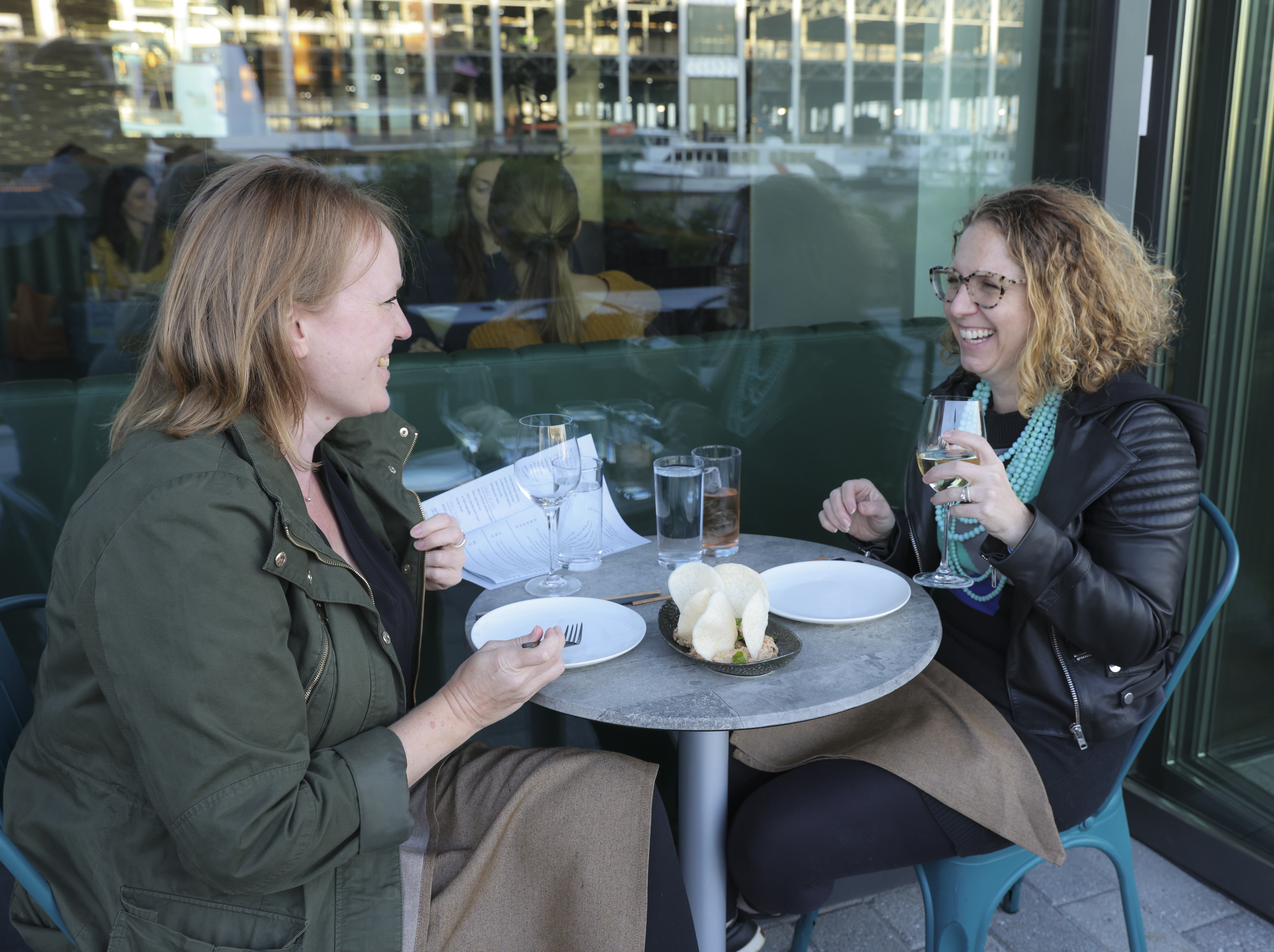 Laura Biringer and Melissa Ostrow enjoying a meal on the outside patio.