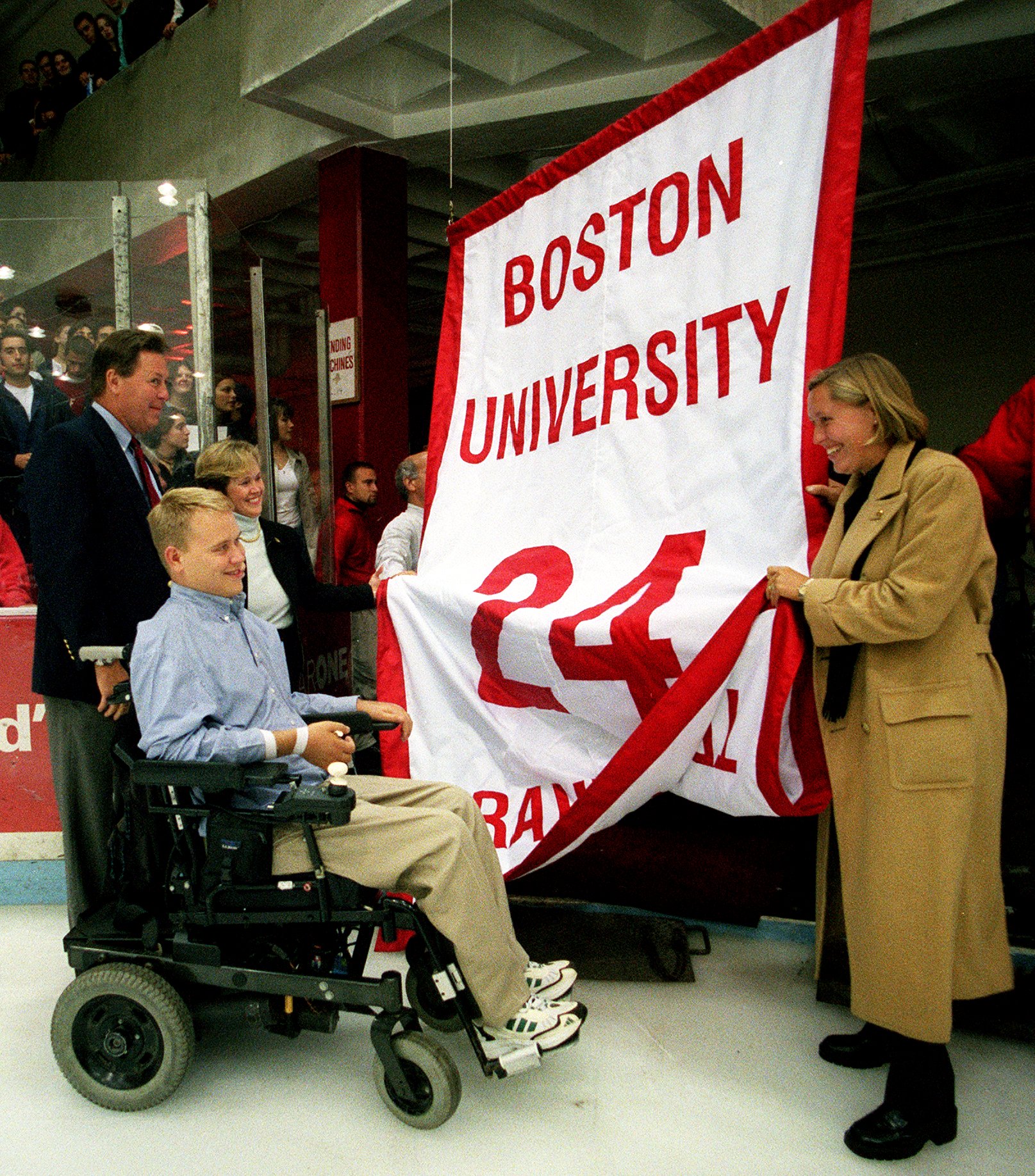 Travis' father, Lee, and his sister, Toby Van Horden, watch with Travis as his No. 24 is retired.