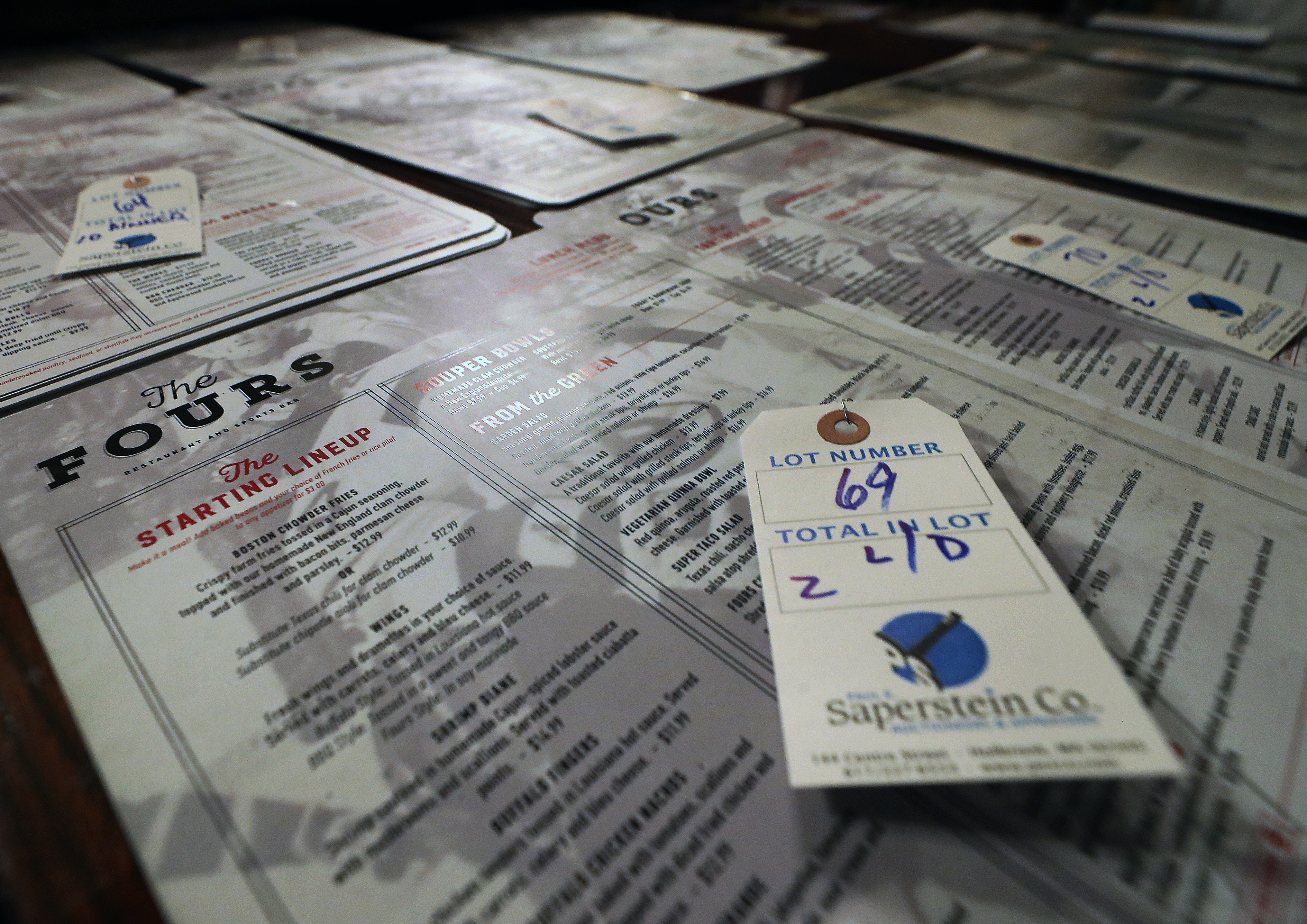 Menus from The Fours on Canal Street are pictured, tagged and ready for auction.