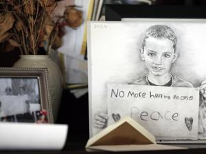 A photo of Martin holding a sign he made for an antiviolence rally became his icon. Artist Dianne Nyitray-Kaericher made a sketch of the image for a calendar and sent it to the Richards.