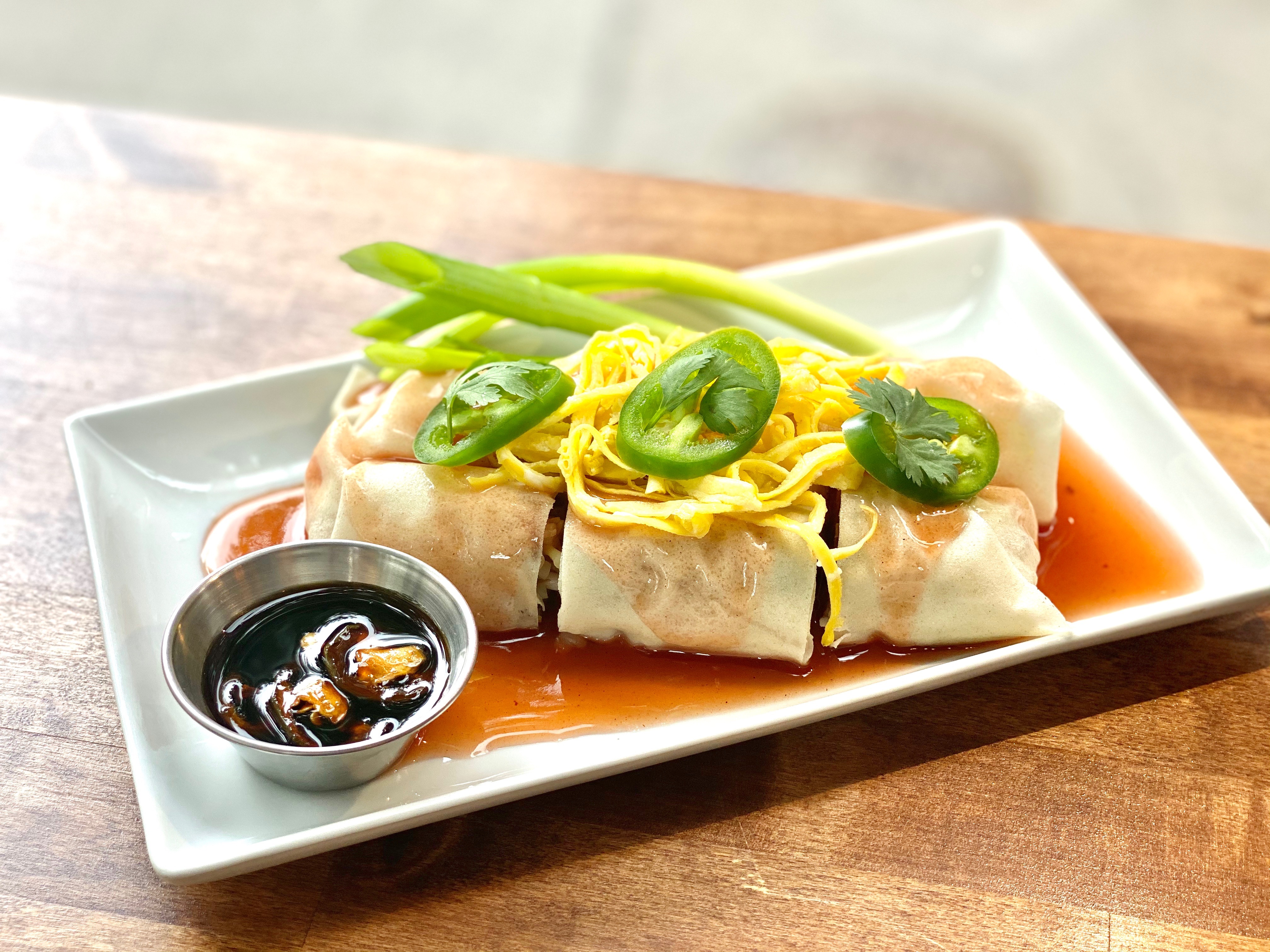 Thai-style fresh summer rolls at Mahaniyom in Brookline. These rolls are stuffed with lots of goodness, including sweet pork sausage, bean sprouts, cucumber, tofu, and omelette. Finished with sweet gravy.