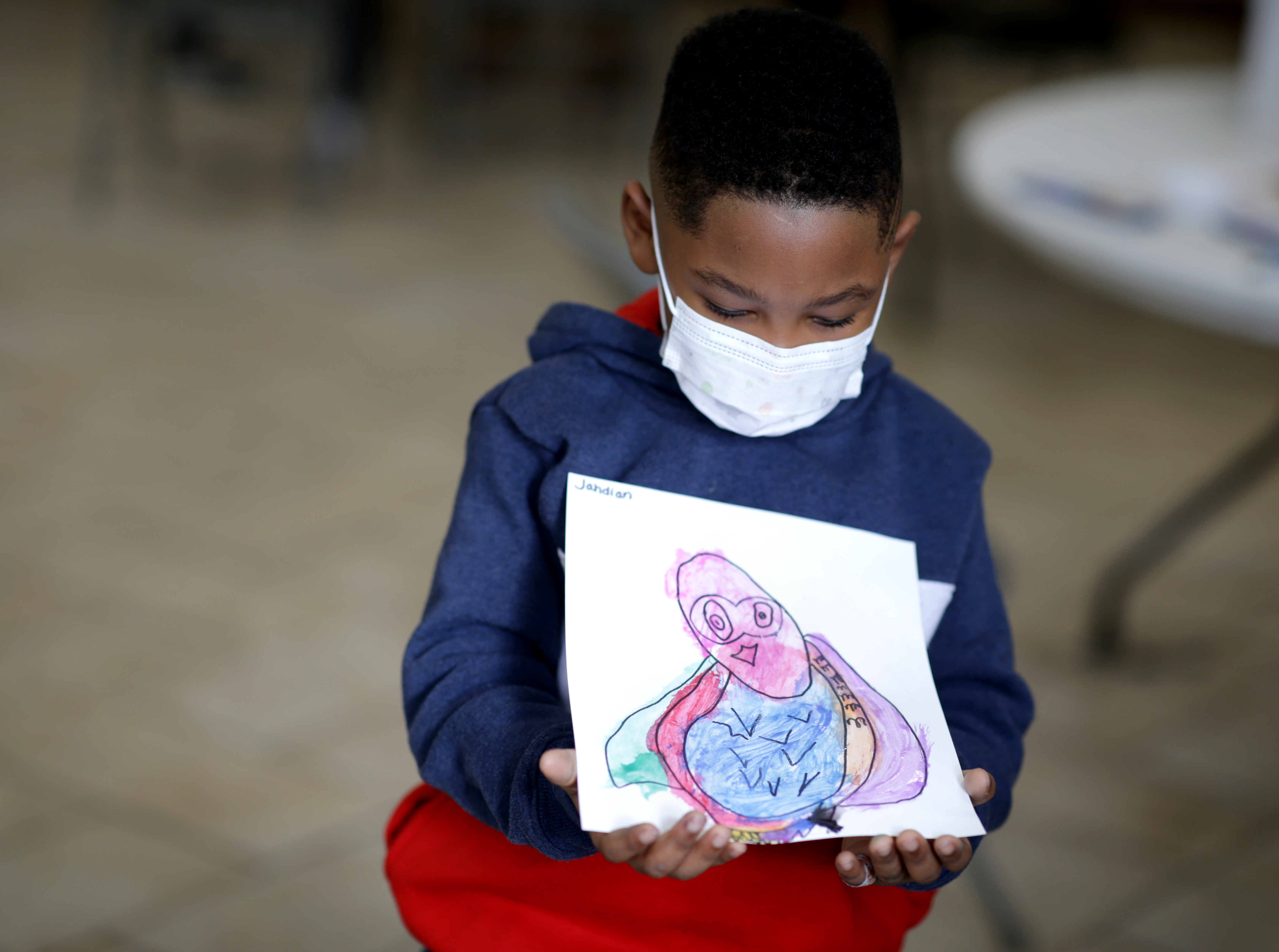 Jahdian Amaya held his drawing of an owl that he made while doing his schoolwork at the Community Learning Collaborative pod at the Cathedral of the Holy Cross.