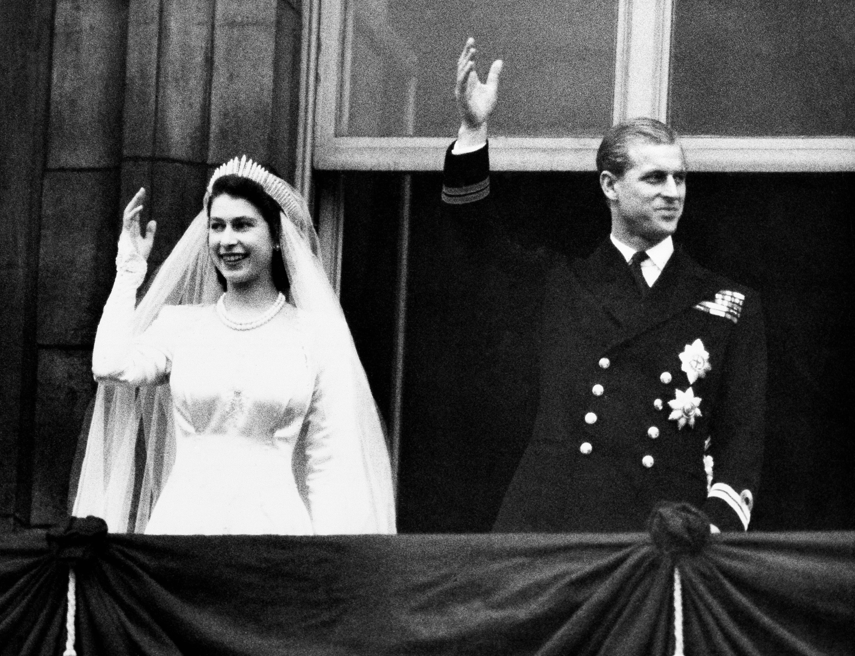 In this Nov. 20, 1947 file photo, Britain's Princess Elizabeth and her husband the Duke of Edinburgh waved to the crowds on their wedding day, from the balcony of Buckingham Palace in London.