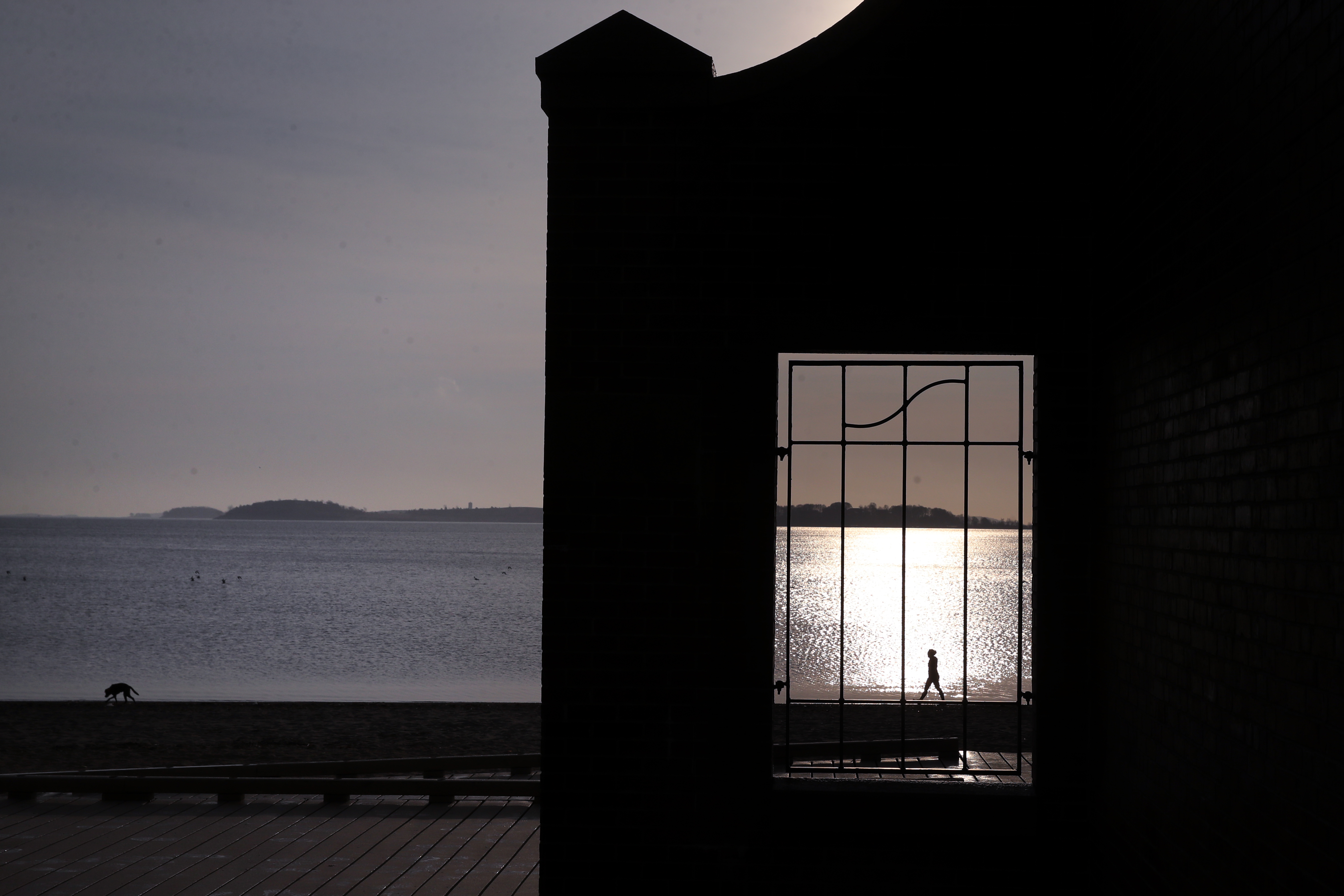 A woman was framed by a window at the Edward J. McCormack Bath House at Carson Beach in Boston on Thursday.