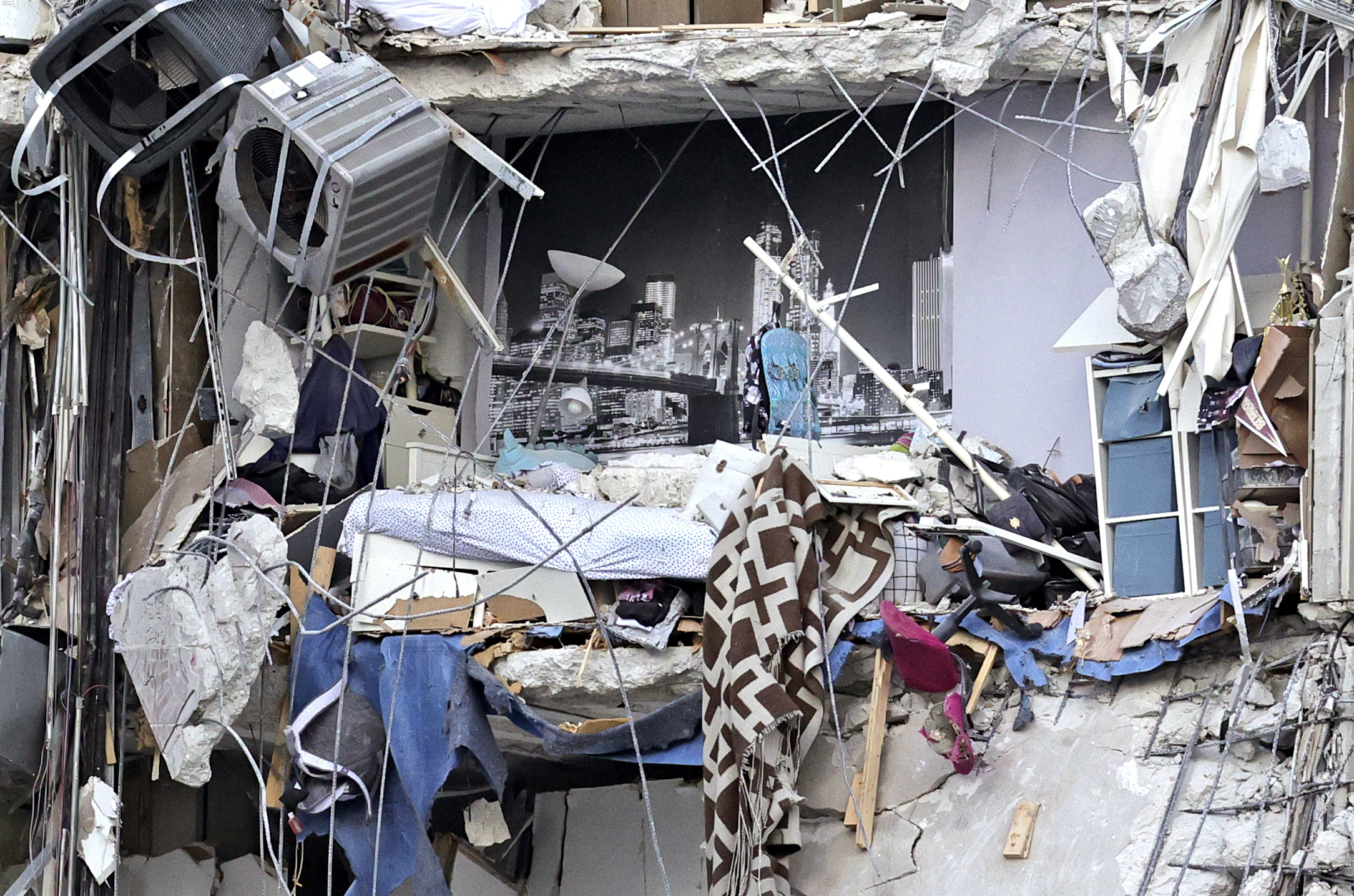 Household items and debris dangled from Champlain Towers South Condo.