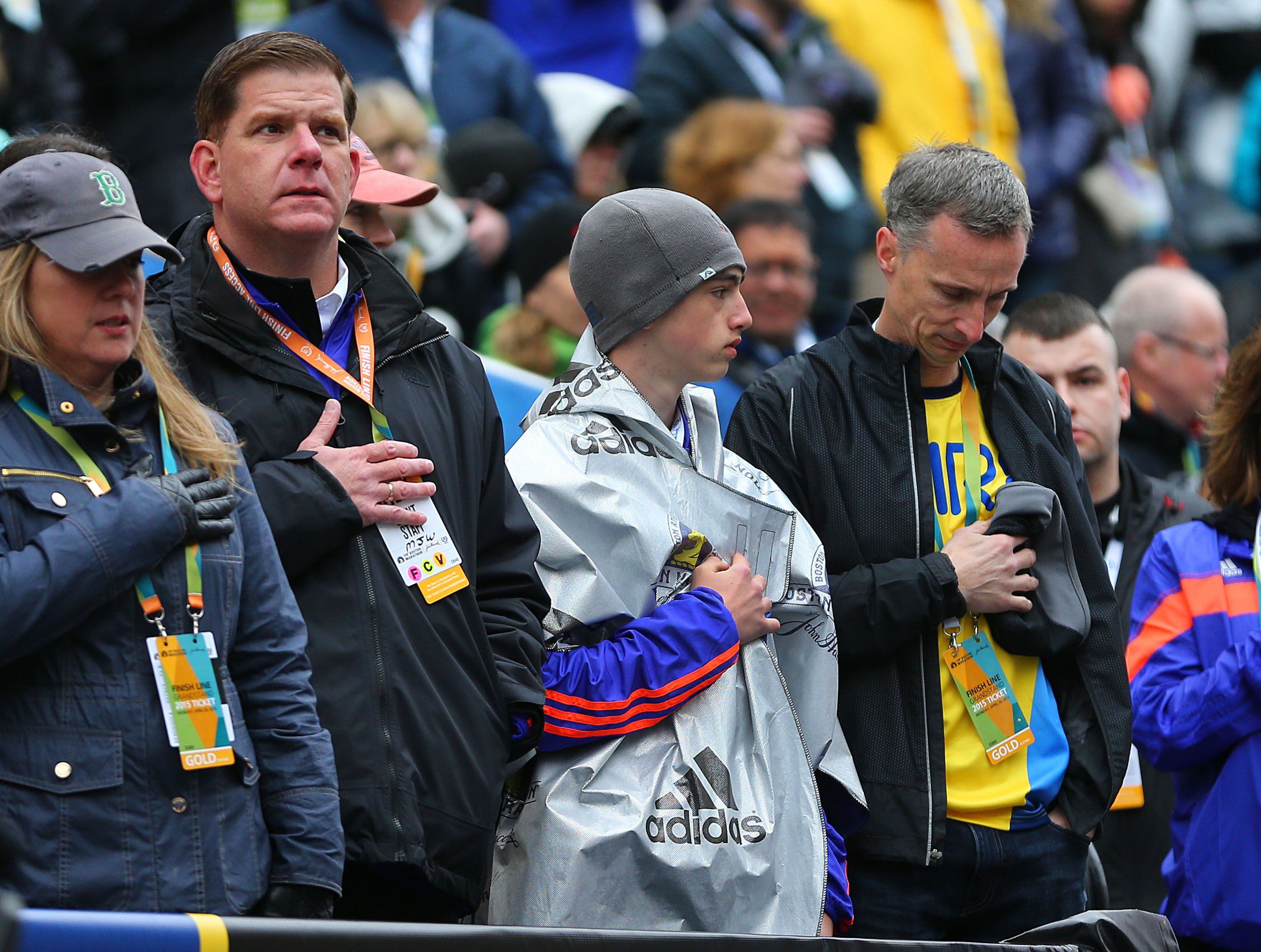 Marty Walsh with Henry Richard and Bill Richard during the national anthem for the women's wheelchair winner at the Boston Marathon finish line in April 2015.