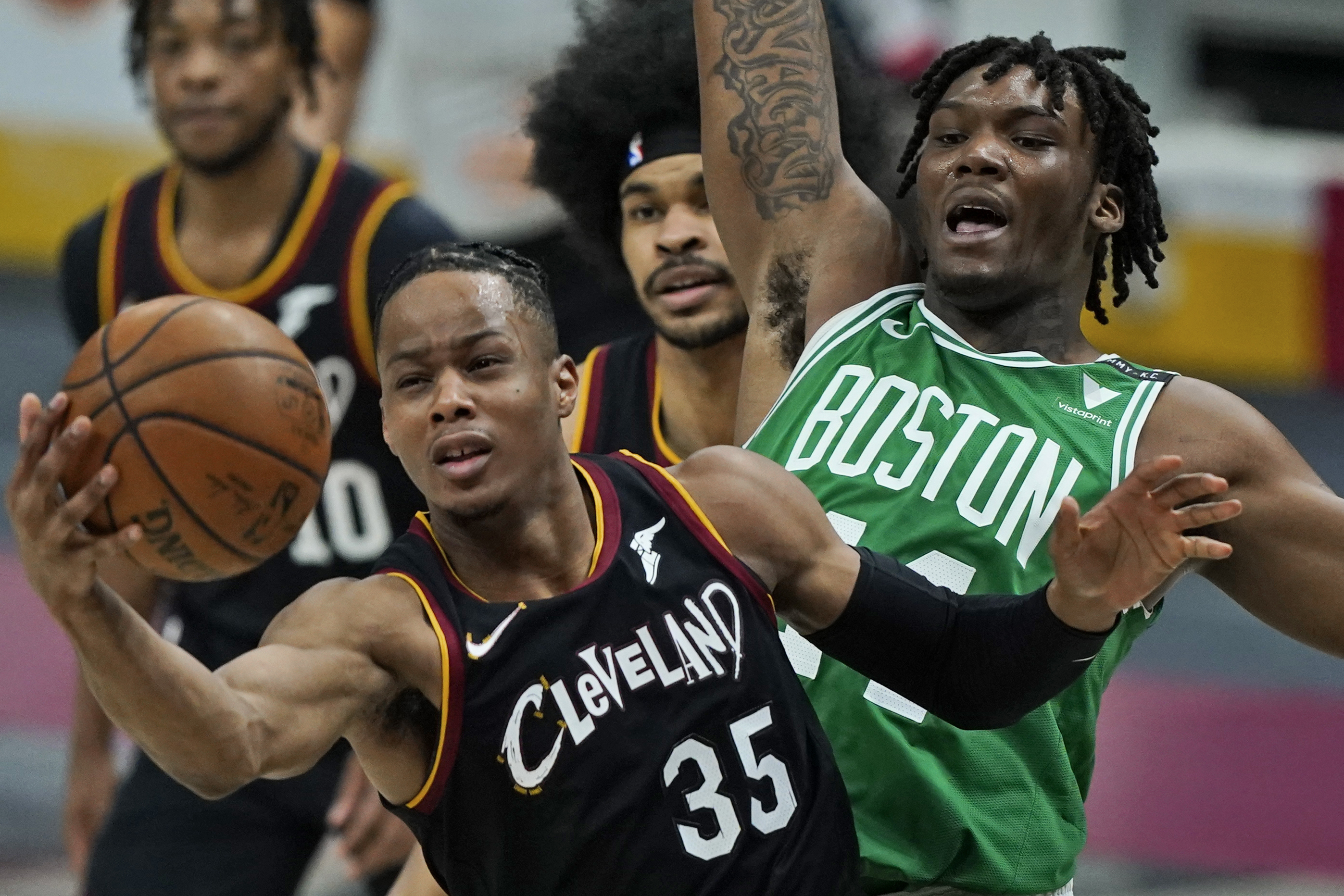 Cleveland's Isaac Okoro grabs a rebound in front of' Robert Williams Wednesday night.