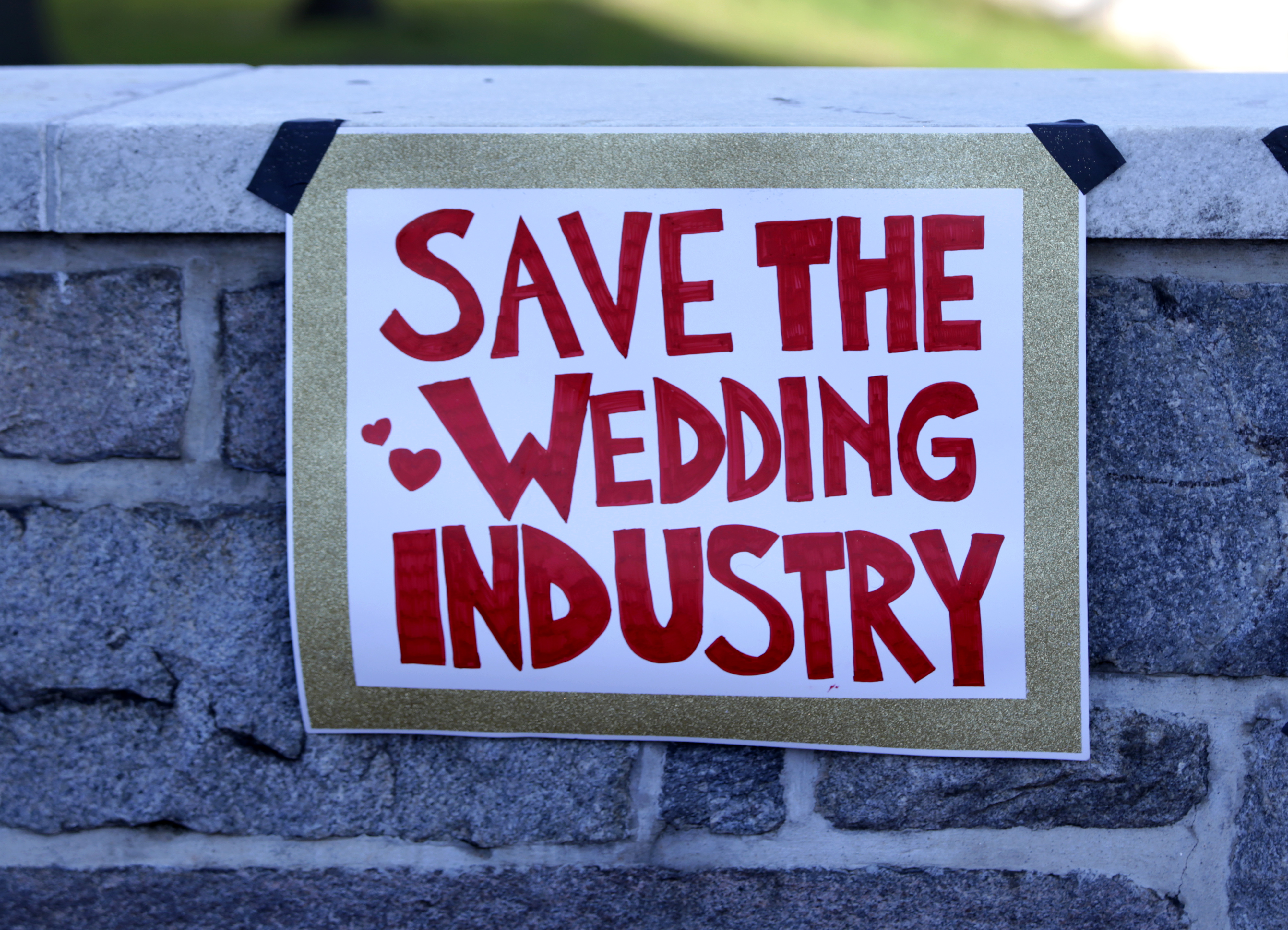 PROVIDENCE -- A poster at at wedding industry rally outside the Veterans Memorial Auditorium on Thursday.