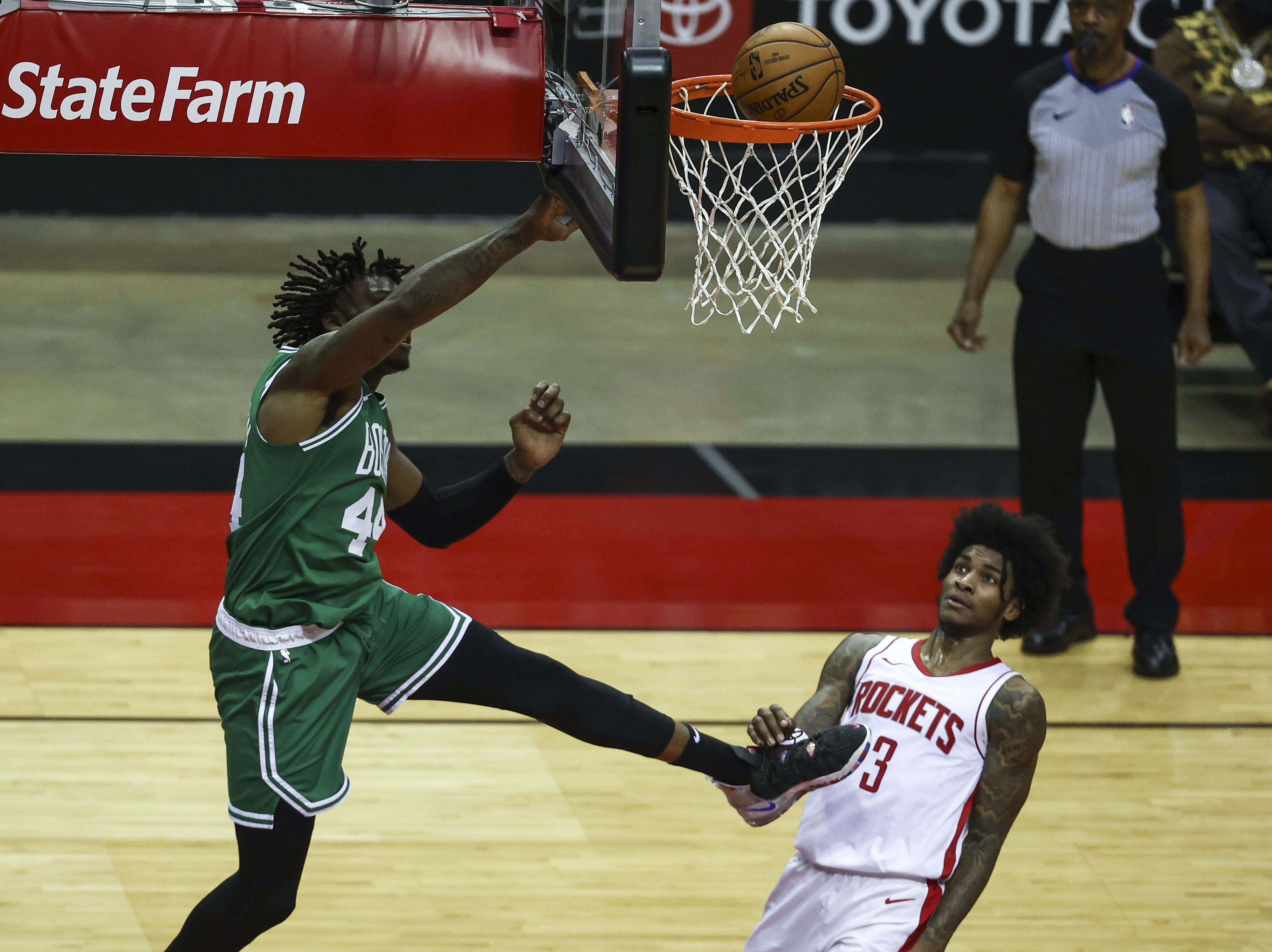 Robert Williams III tips a ball into the basket as Houston's Kevin Porter Jr. defends during the third quarter of Sunday's gane.