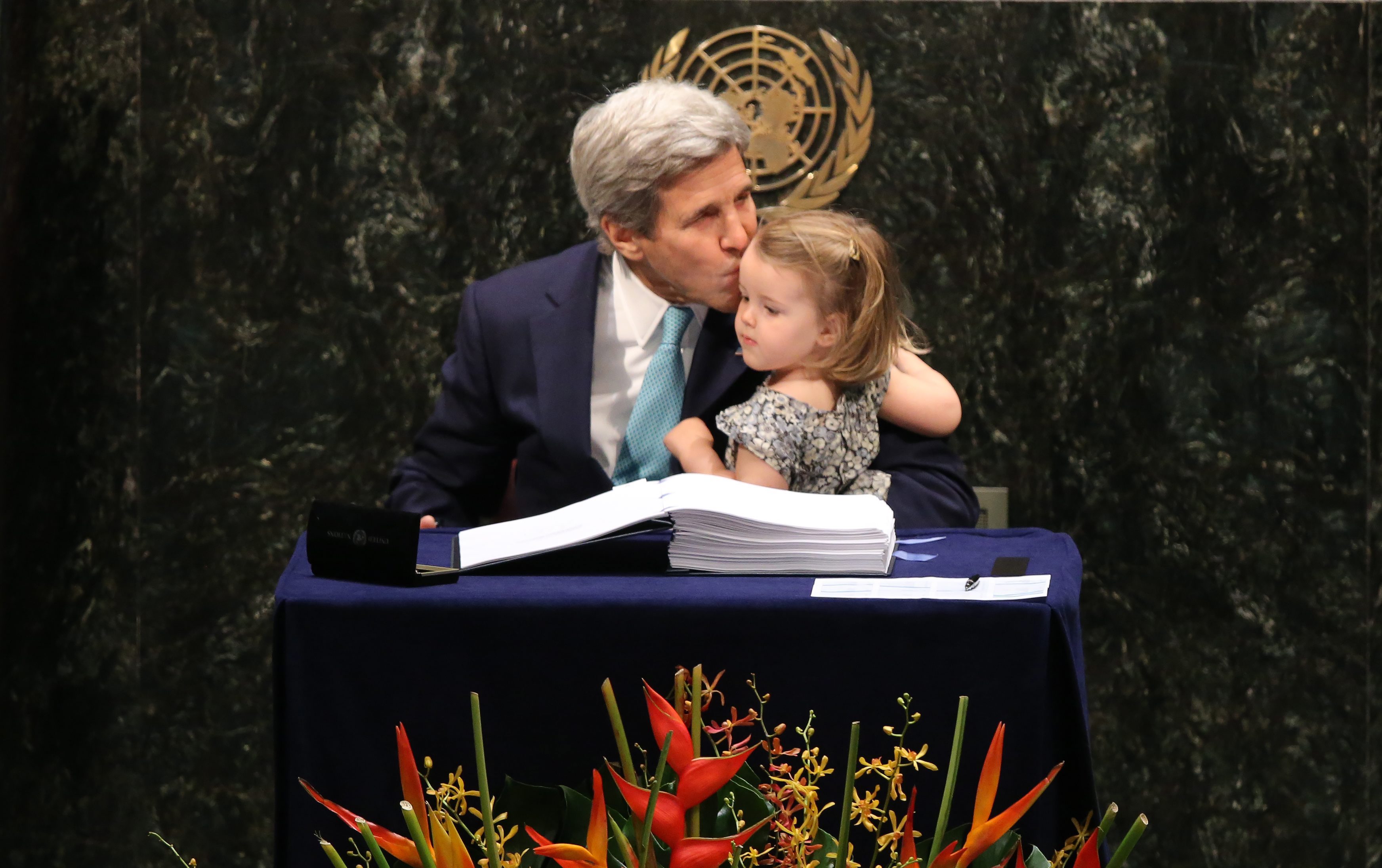Then Secretary of State John Kerry held his granddaughter Isabelle Dobbs-Higginson after signing the Paris Climate Accord at the United Nations headquarters in New York in 2016.