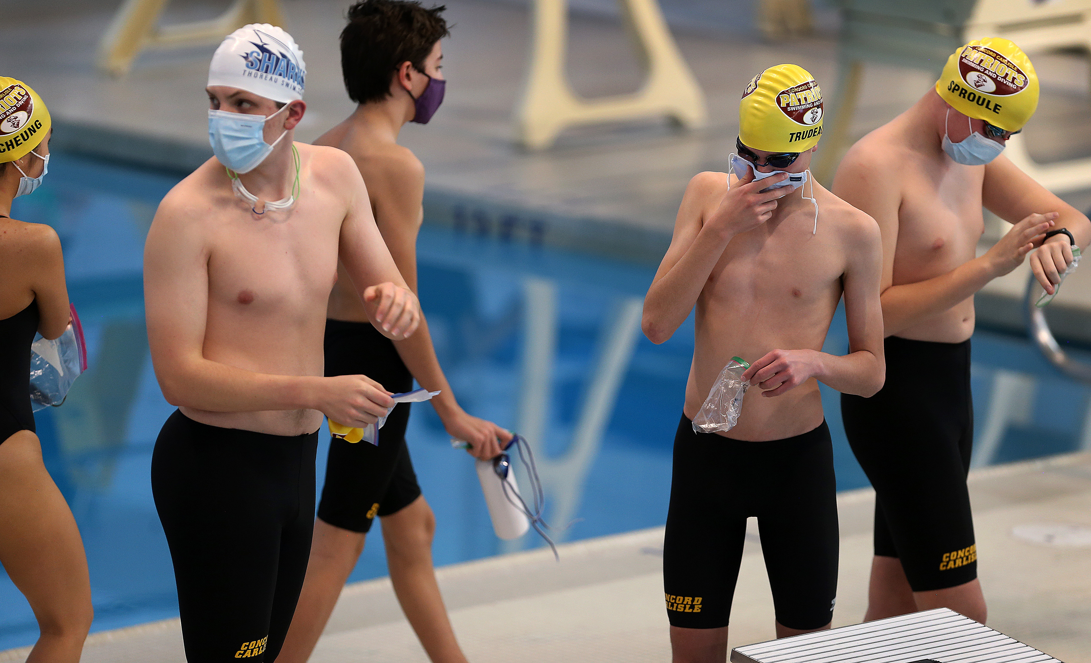 Concord-Carlisle swimmers wore masks on the pool deck for a meet during the winter season.