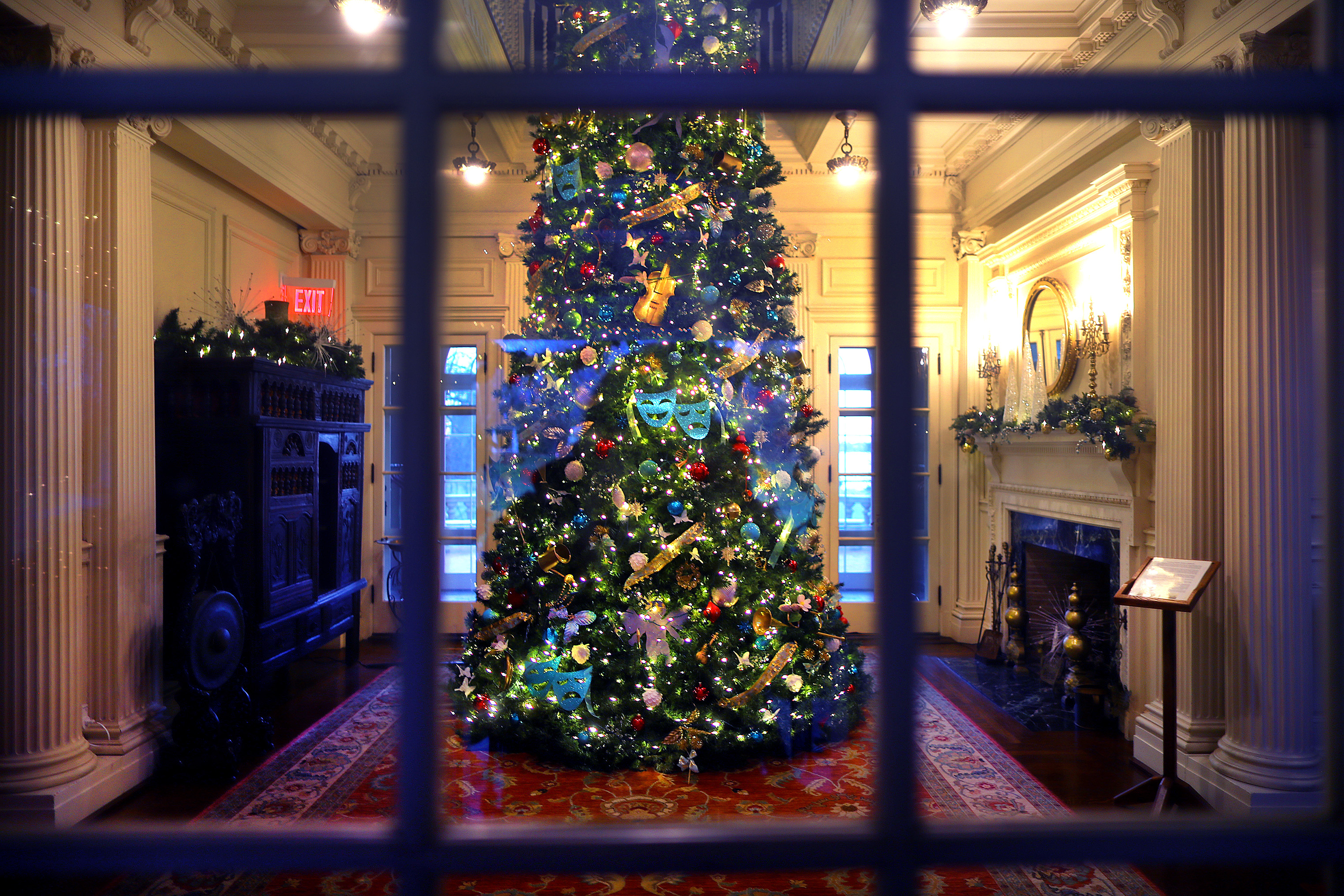 A Christmas tree seen through the front French doors at Blithewold mansion in Bristol, R.I.