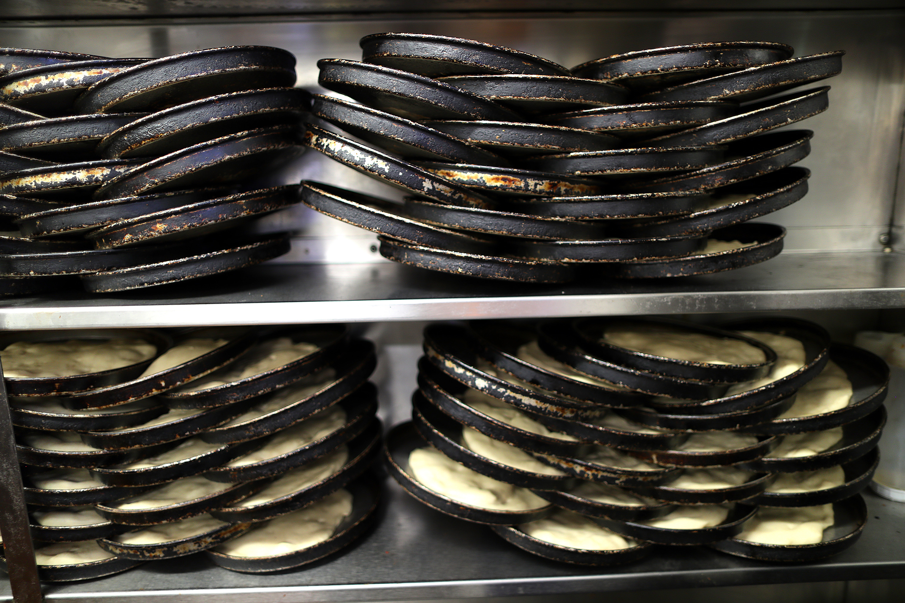 Dough rests for several hours in their pans at the Lynwood Cafe.