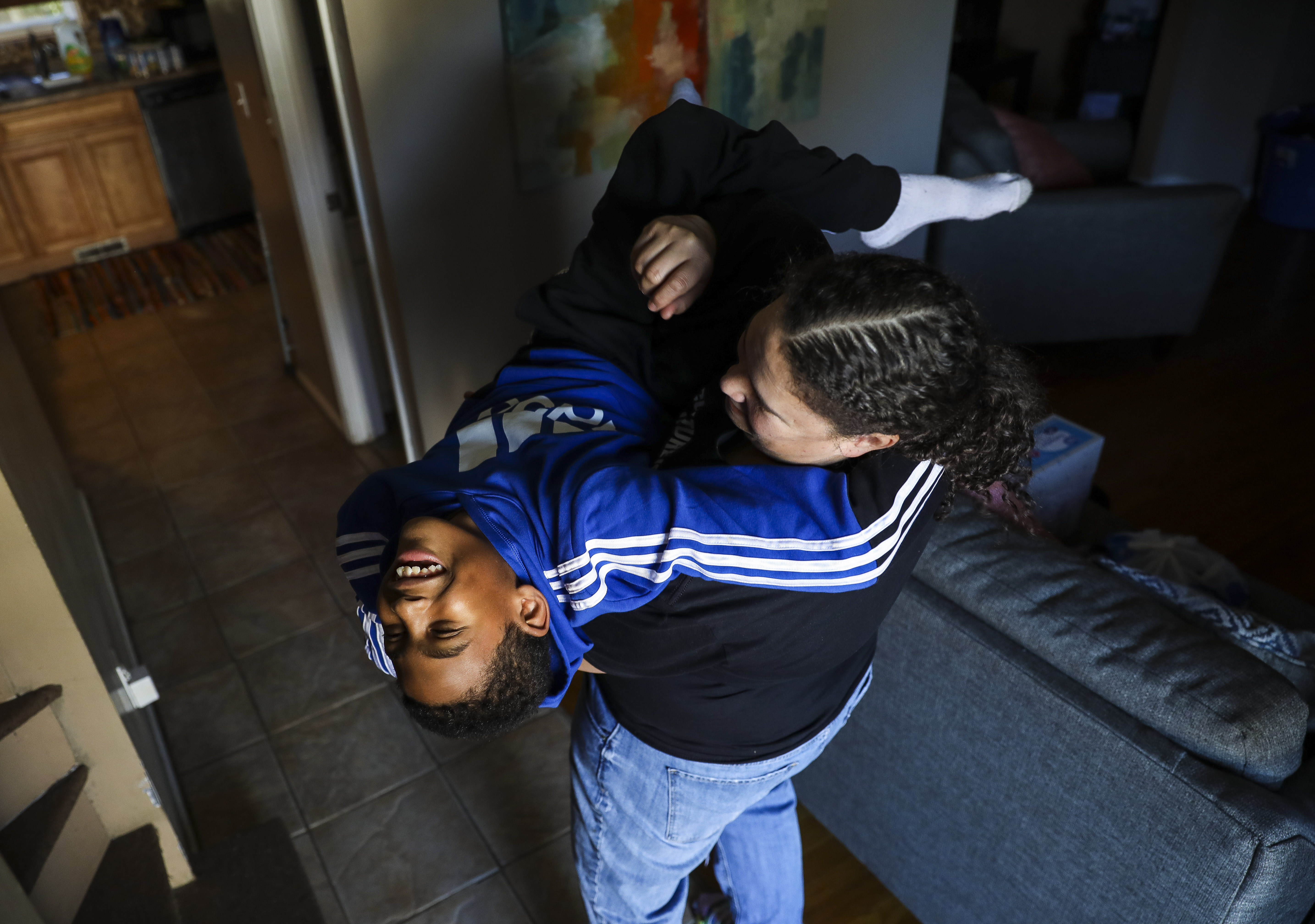 Yahaira Lopez tickled her 10-year-old son, Yassiah, while he took a break from remote learning in their Randolph home.
