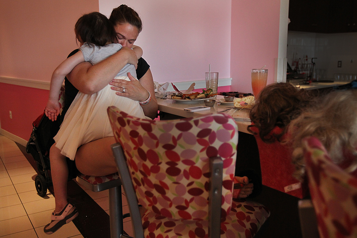 Rachael Cronk hugged Caroline on a mall trip to the American Girl doll store. Caroline was diagnosed with a rare cancer last year.