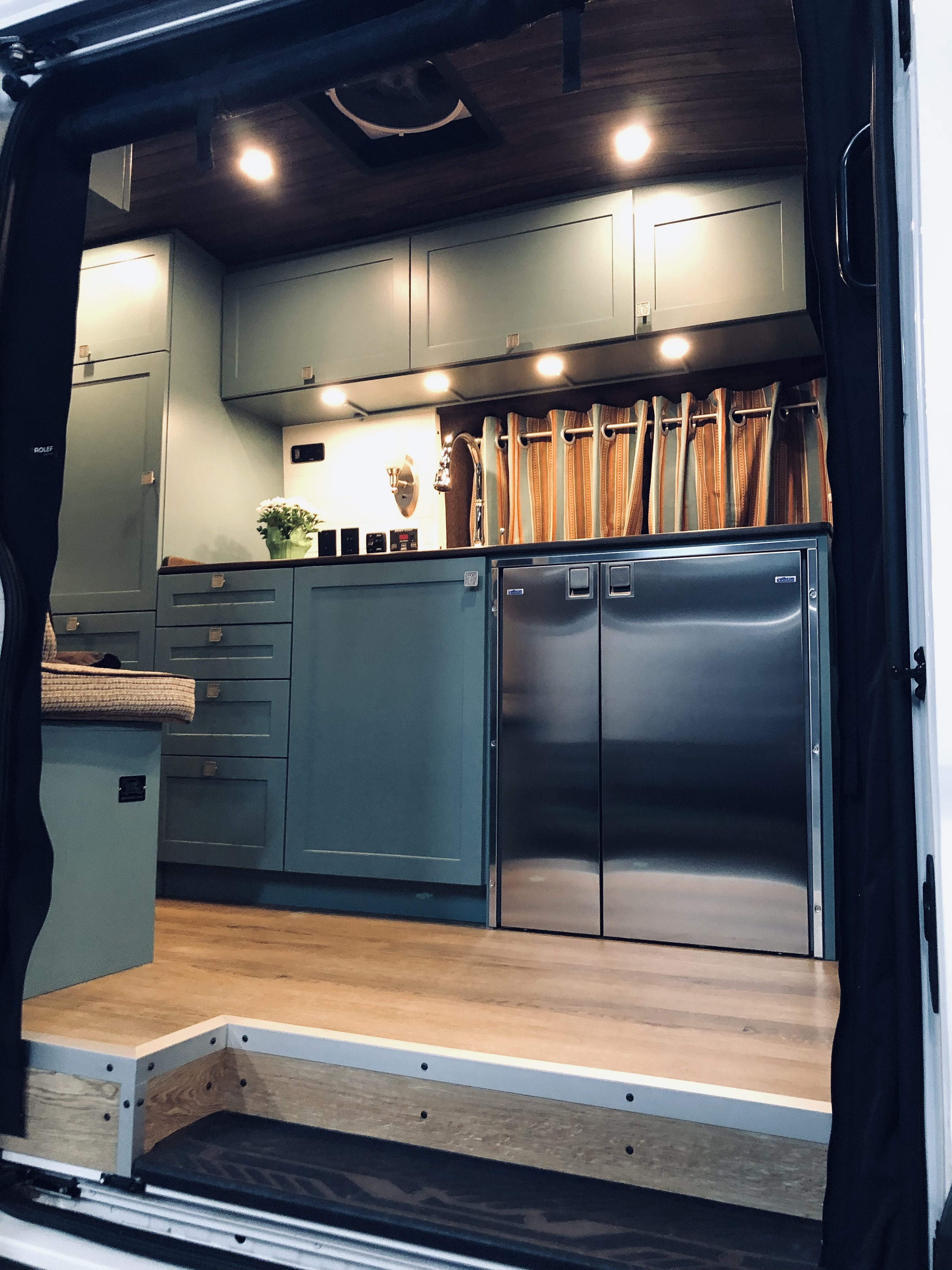 Nirvana Upfitters customized Kirstin Lynde's camper van with solar panels, cabinetry, and exterior awnings.