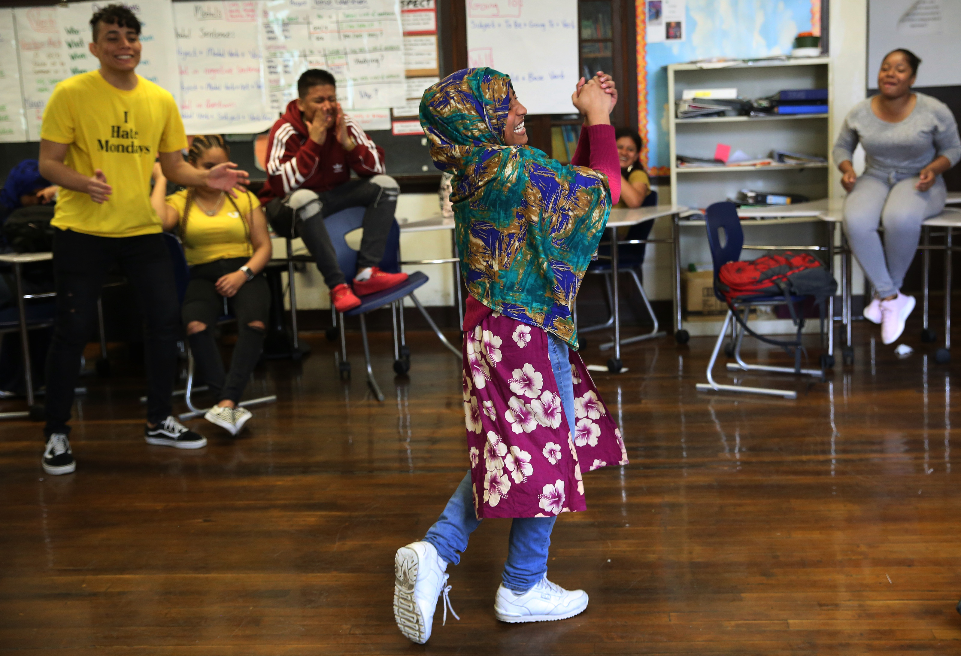 Khadiza Akter, from Bangladesh, cheered after pretending to knock out teacher Ramon Trinidad during a play fighting scene. The ESL students were working with actors as a way of better understanding the book they were reading in class at Brighton High.