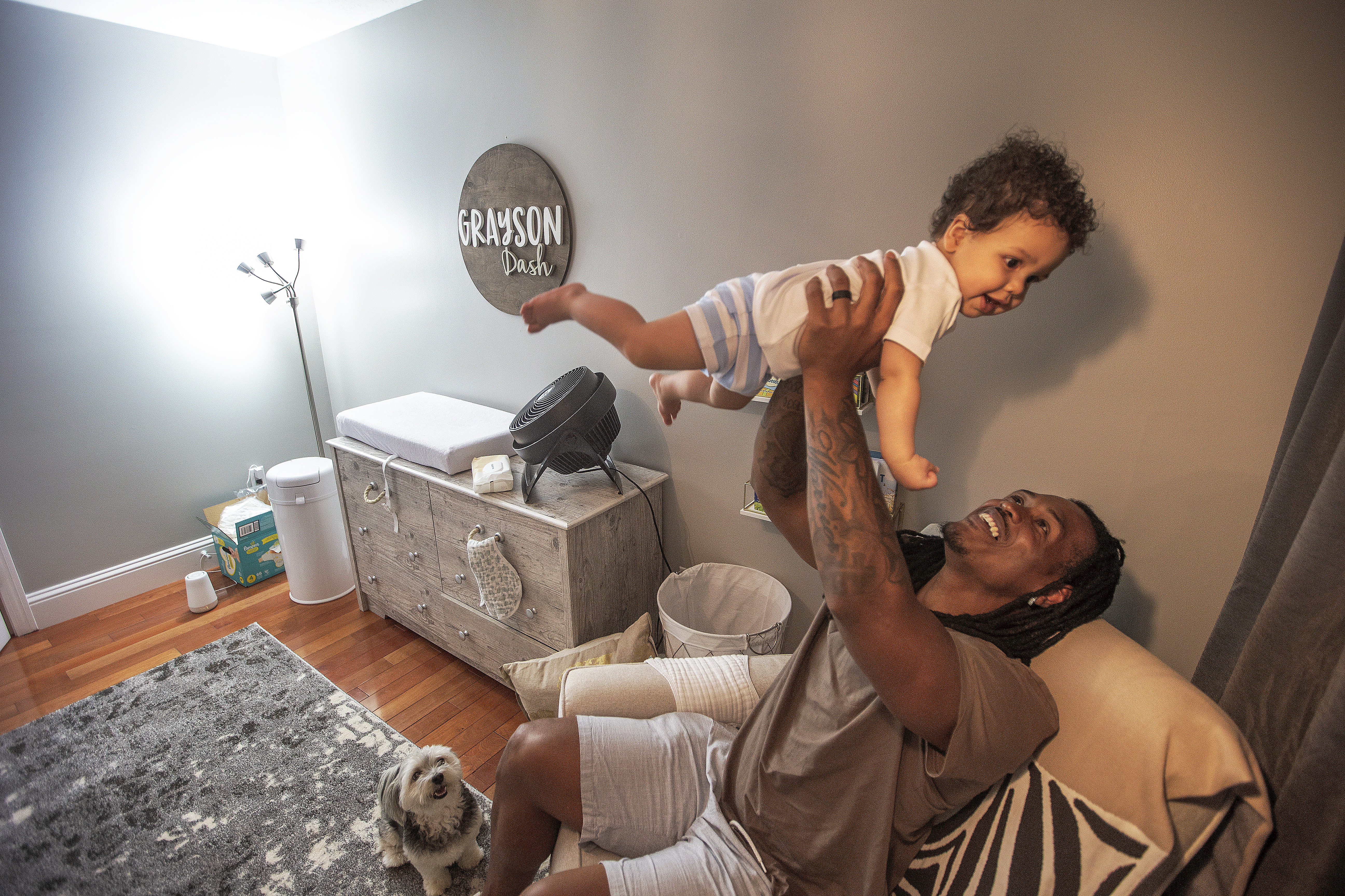 Father and son enjoy each other's company in their Foxborough home.