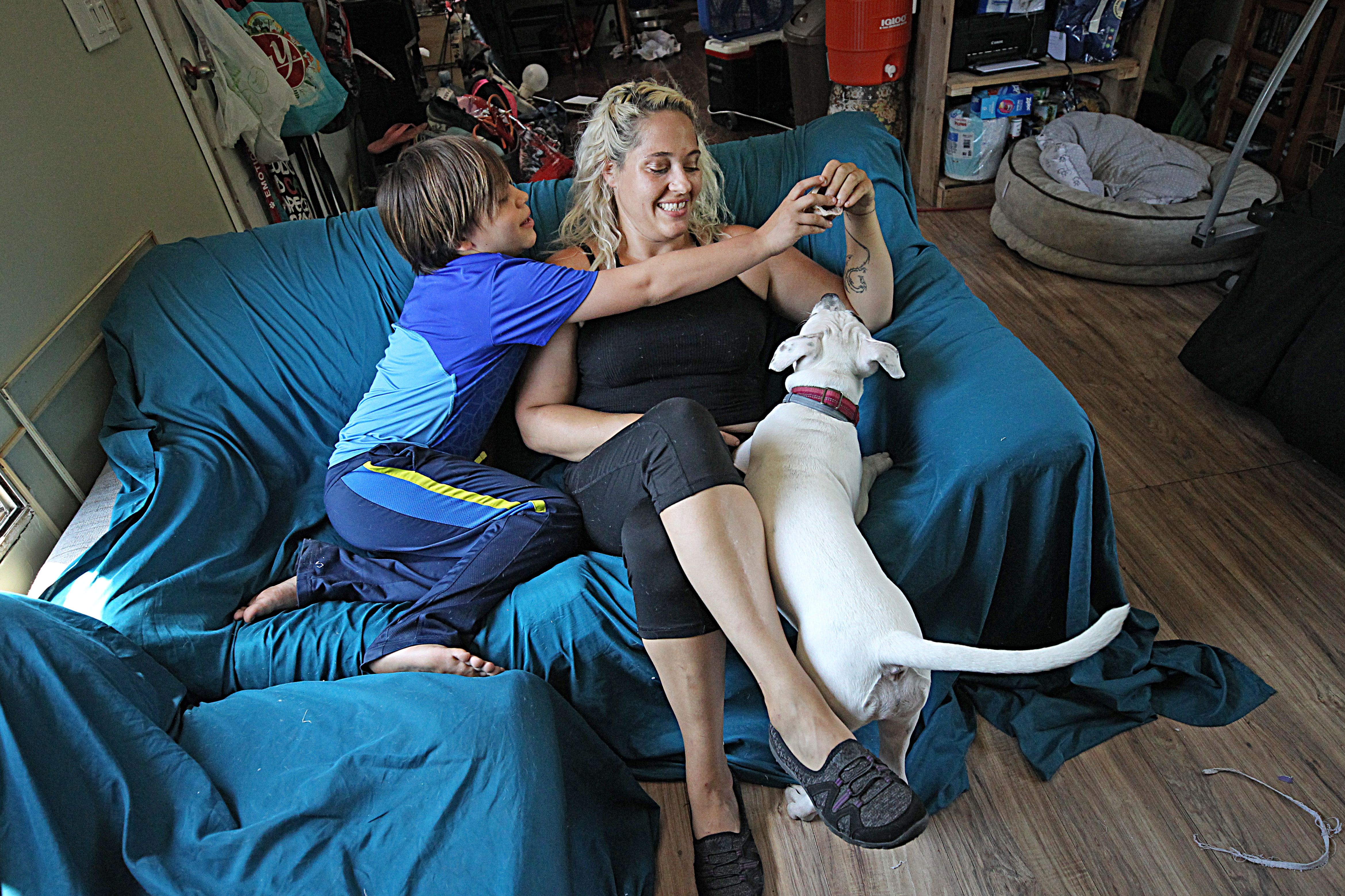 “If the locals aren’t making any money, I’m not making any money either,” said Laci Parker, a massage therapist, with her youngest son David.