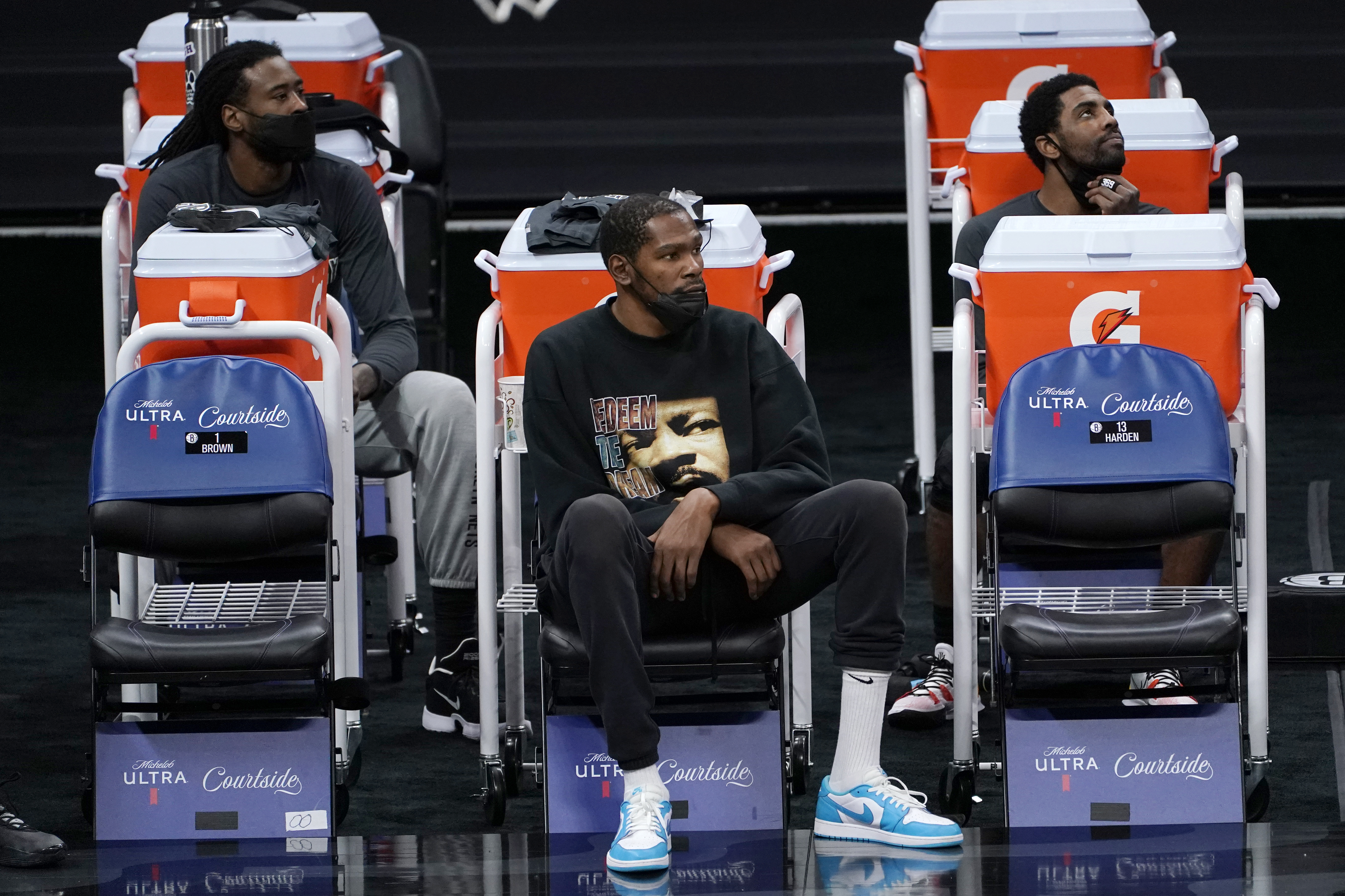 DeAndre Jordan, left, Kevin Durant, center, and Kyrie Irving watched the Nets' game against the Kings on Monday. Durant did not play due to an injury.