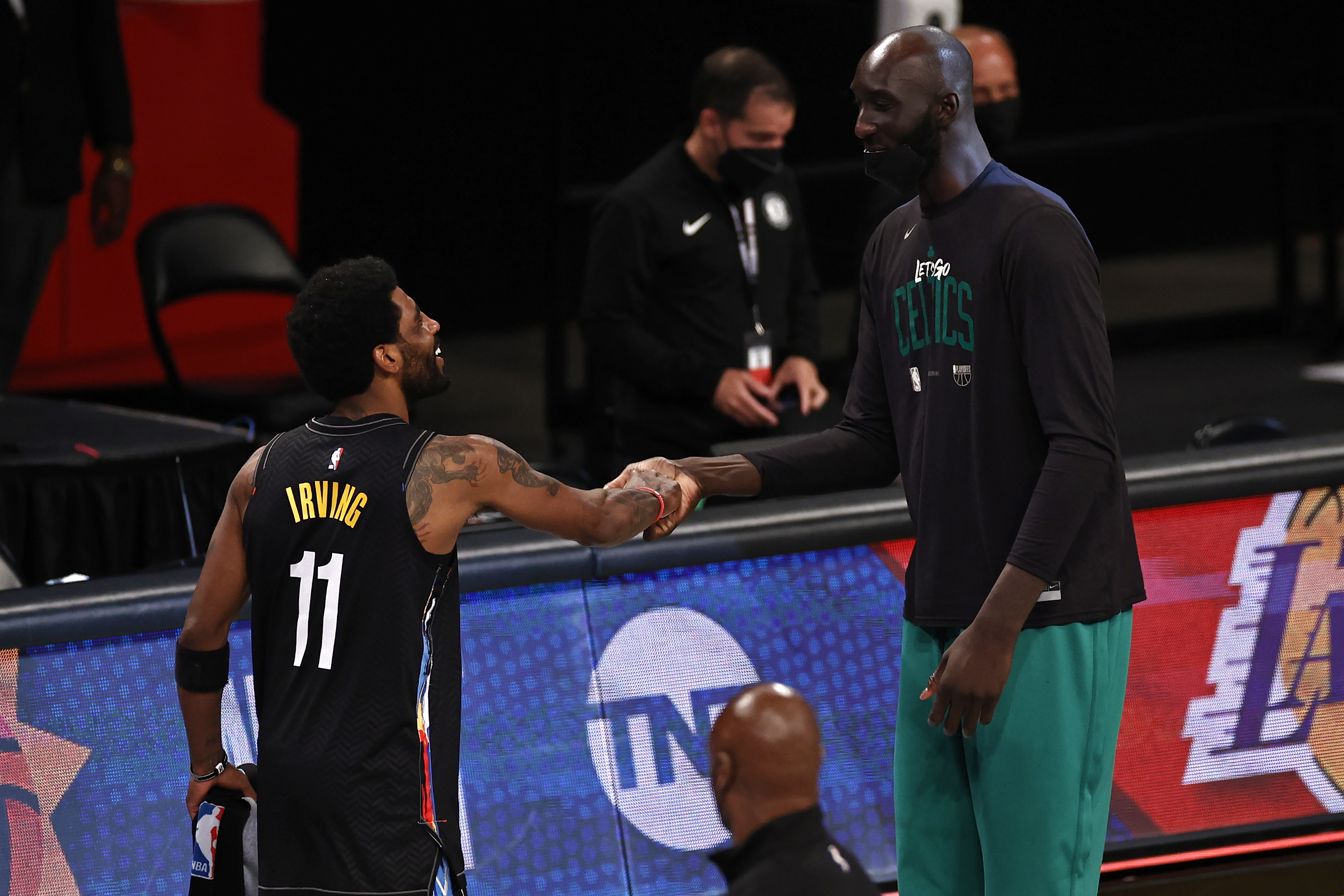 Kyrie Irving shakes hands with Tacko Fall after Tuesday's game.