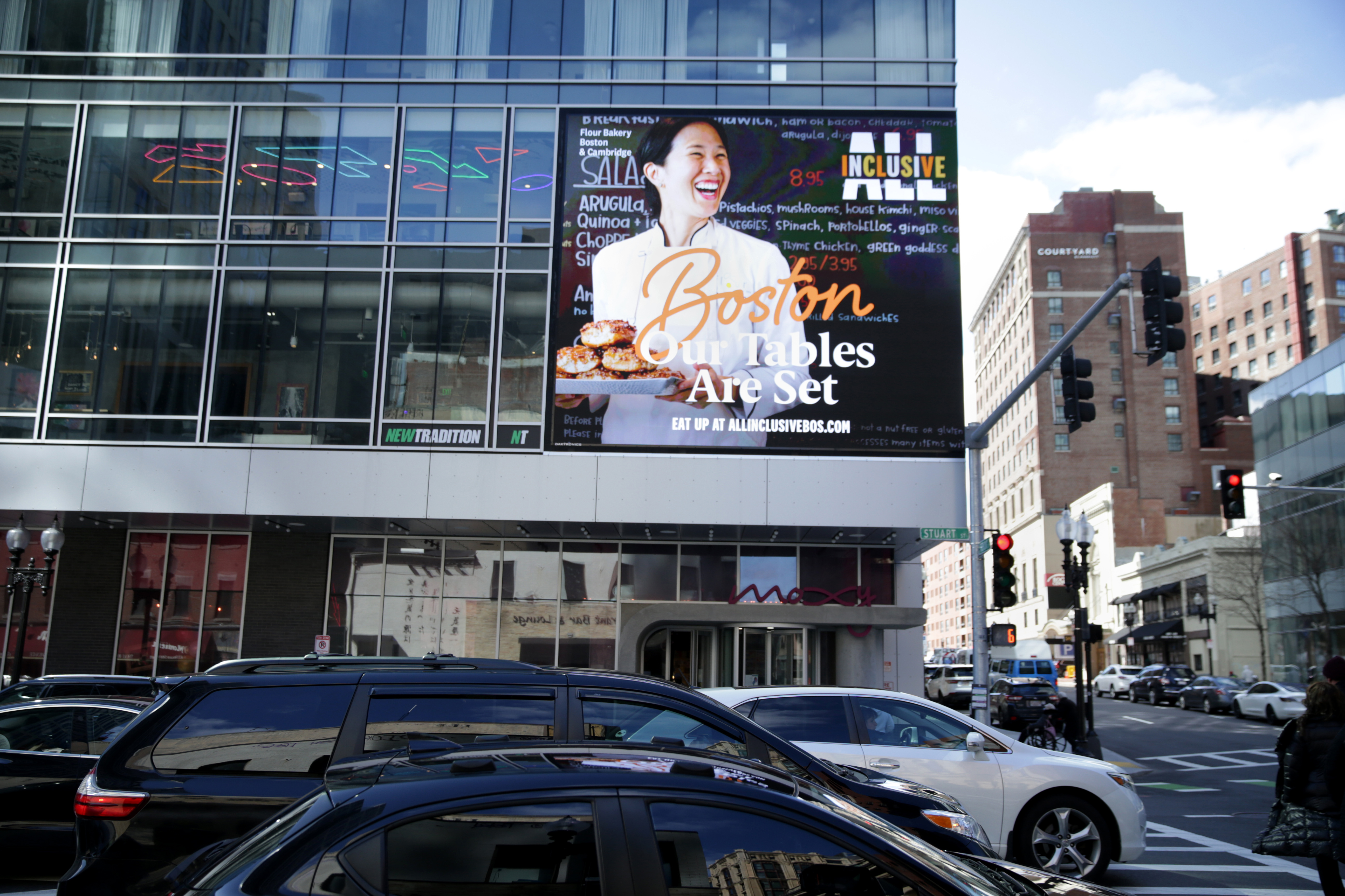 An image of Boston's "All Inclusive" tourism campaign is featured on the facade of the Moxie Hotel.