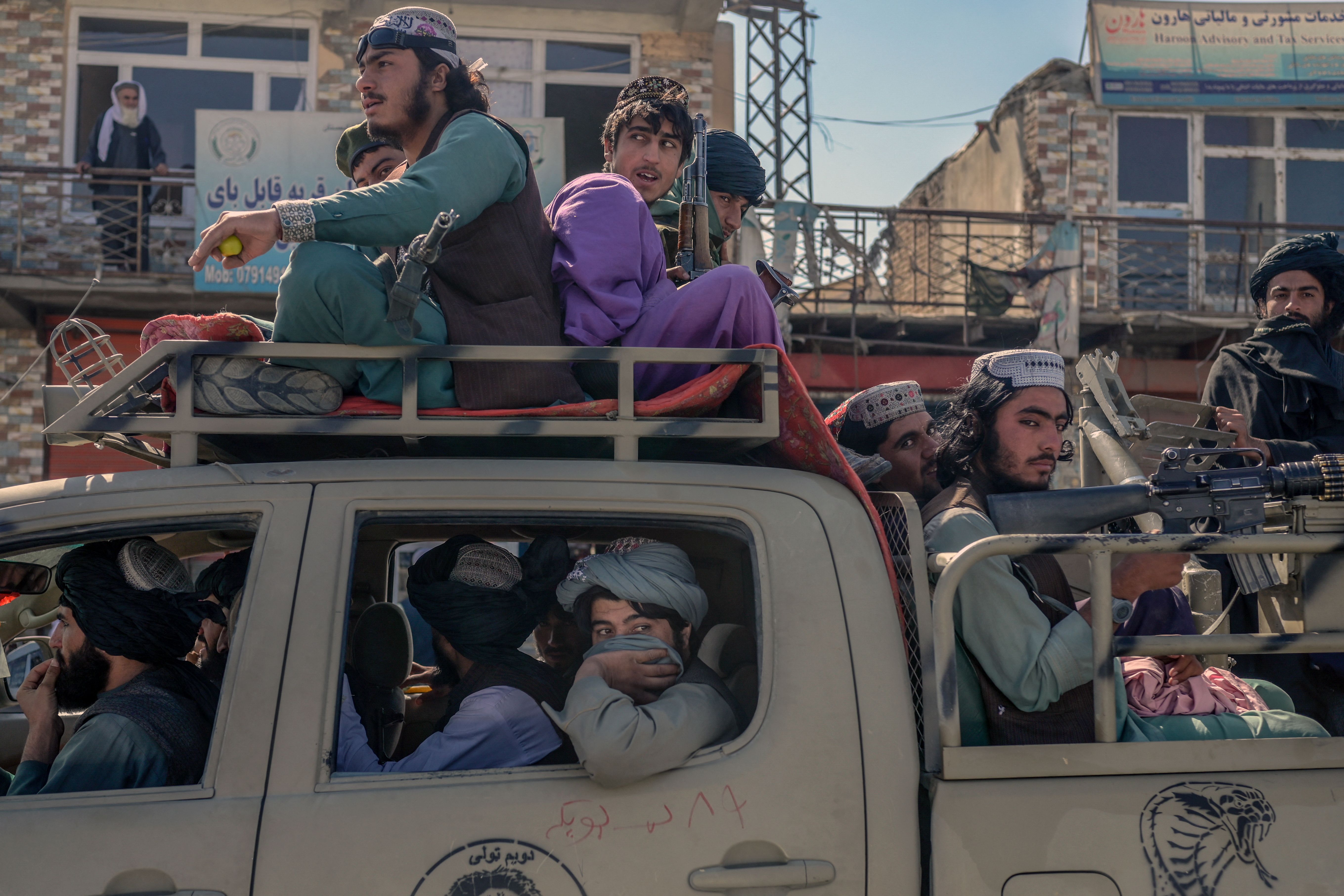 Taliban members drove along a road in the center of Kabul on Oct. 14.