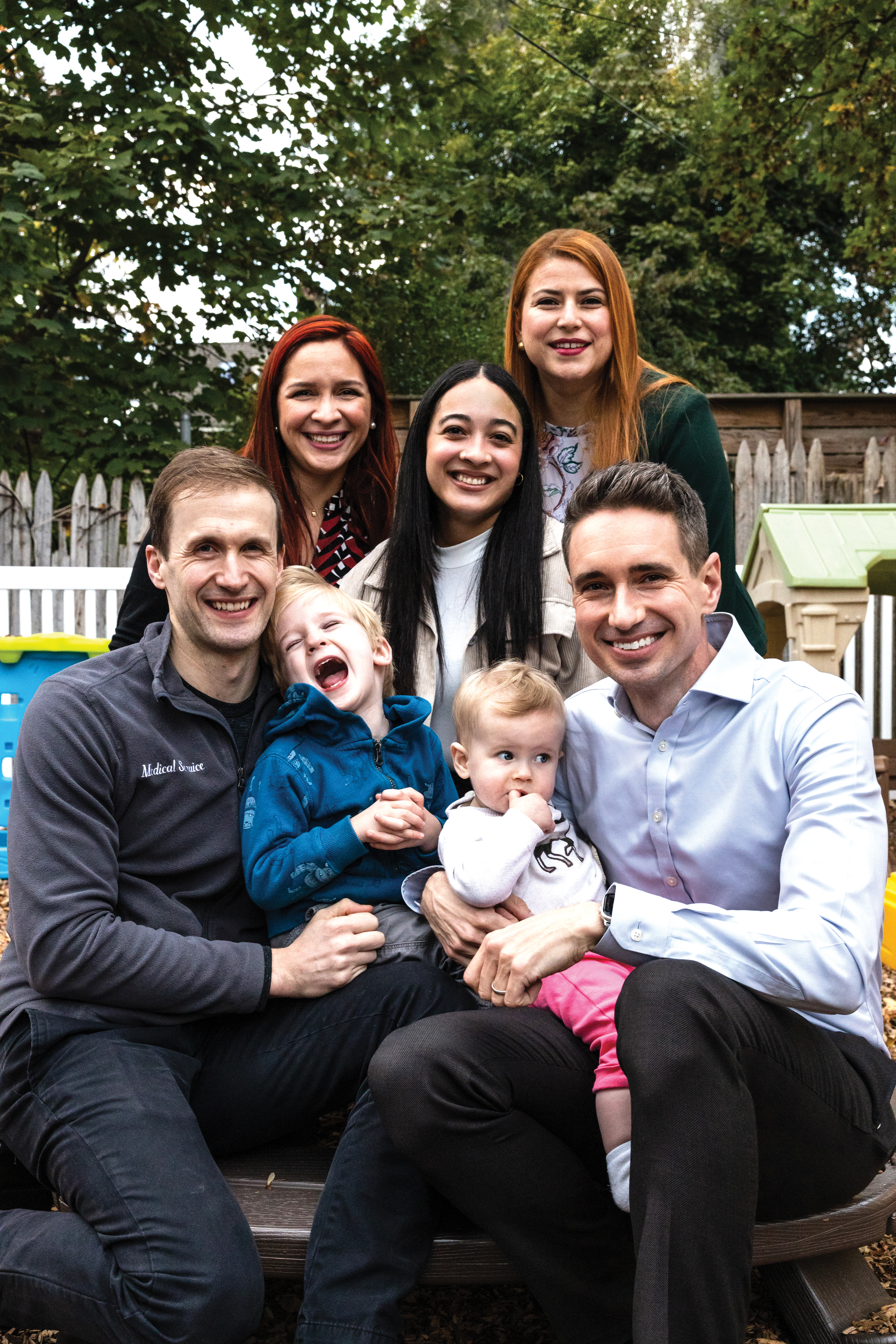 Front row: Jason Vassy (left) with son, Jeremy; Scott Hadland (right) with daughter, Louisa. Back row, from left: Pine Village Preschool director Johanneryck Valladares, nanny Yaidy Abreu, and Pine Village teacher Sarvia Anaya.