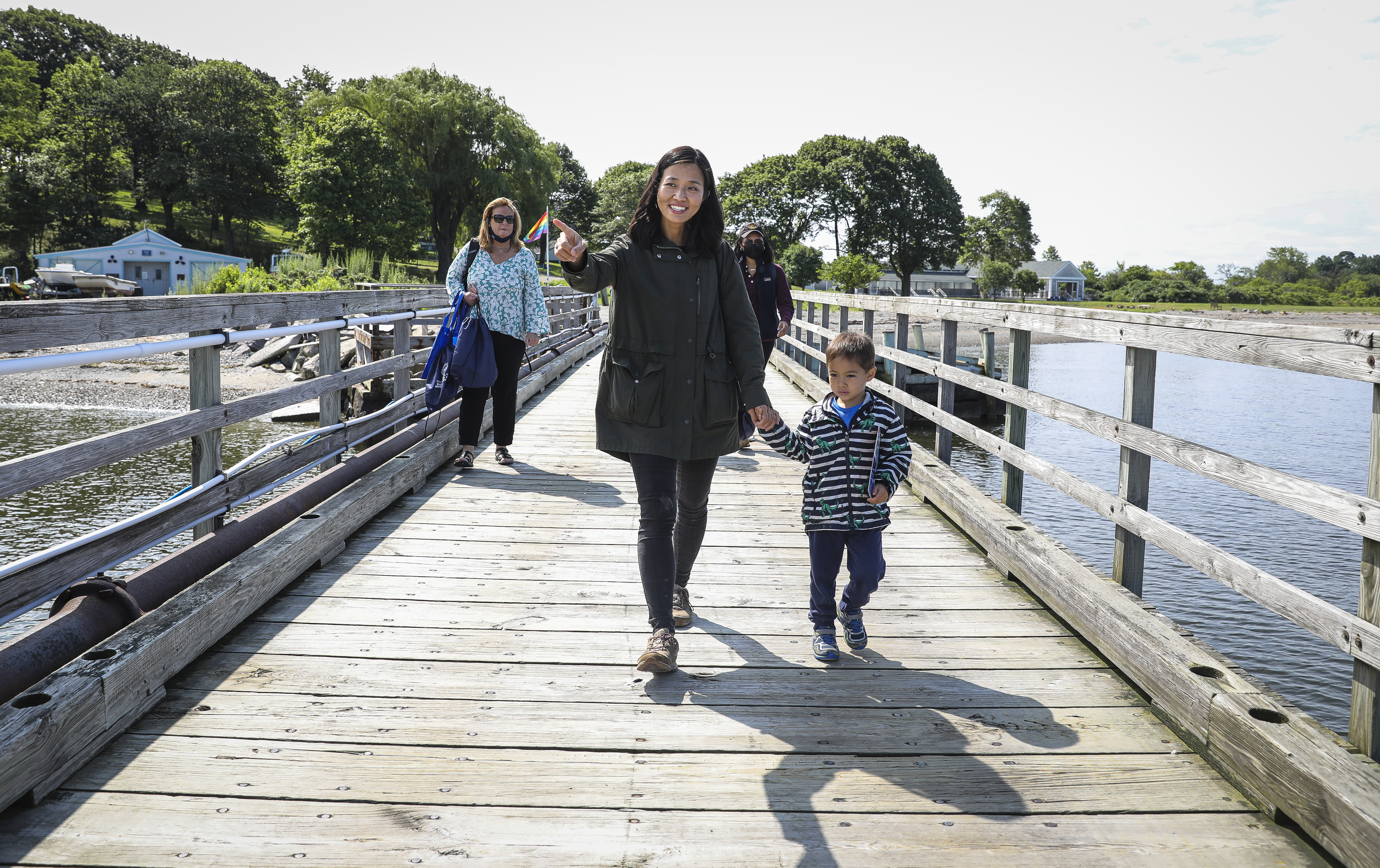 Michelle Wu walked down the dock with her 3-year-old son Cass while visiting Thompson Island.