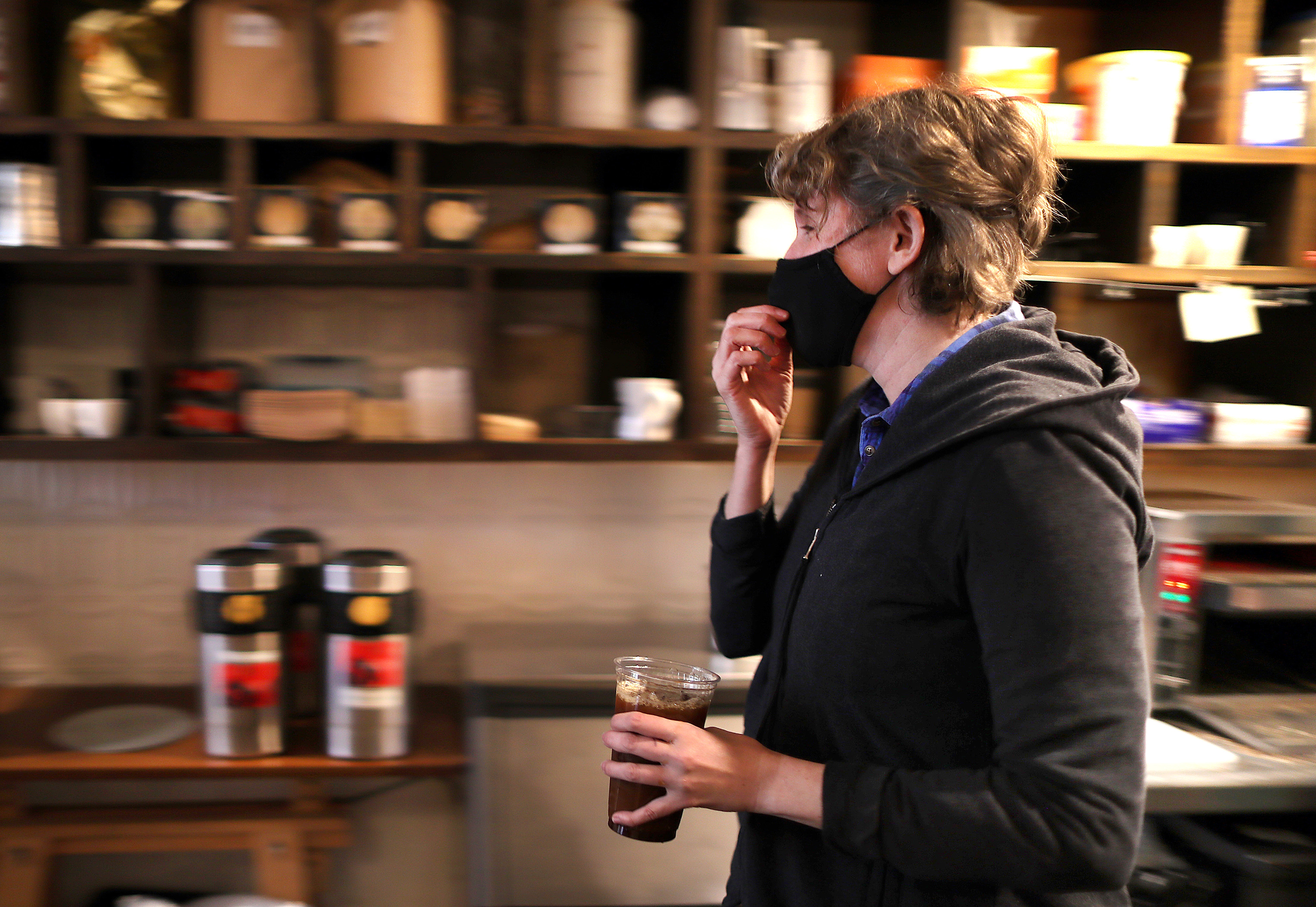 White Electric Coffee shop co-owner Chloe Chassaing brings an order she made to a customer at the window.
