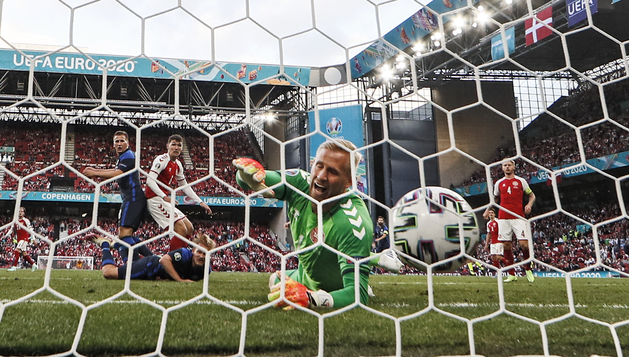 Finland's Joel Pohjanpalo (on ground) scored the only goal in Saturday's match, on a rare error by Denmark goalkeeper Kasper Schmeichel (in green).