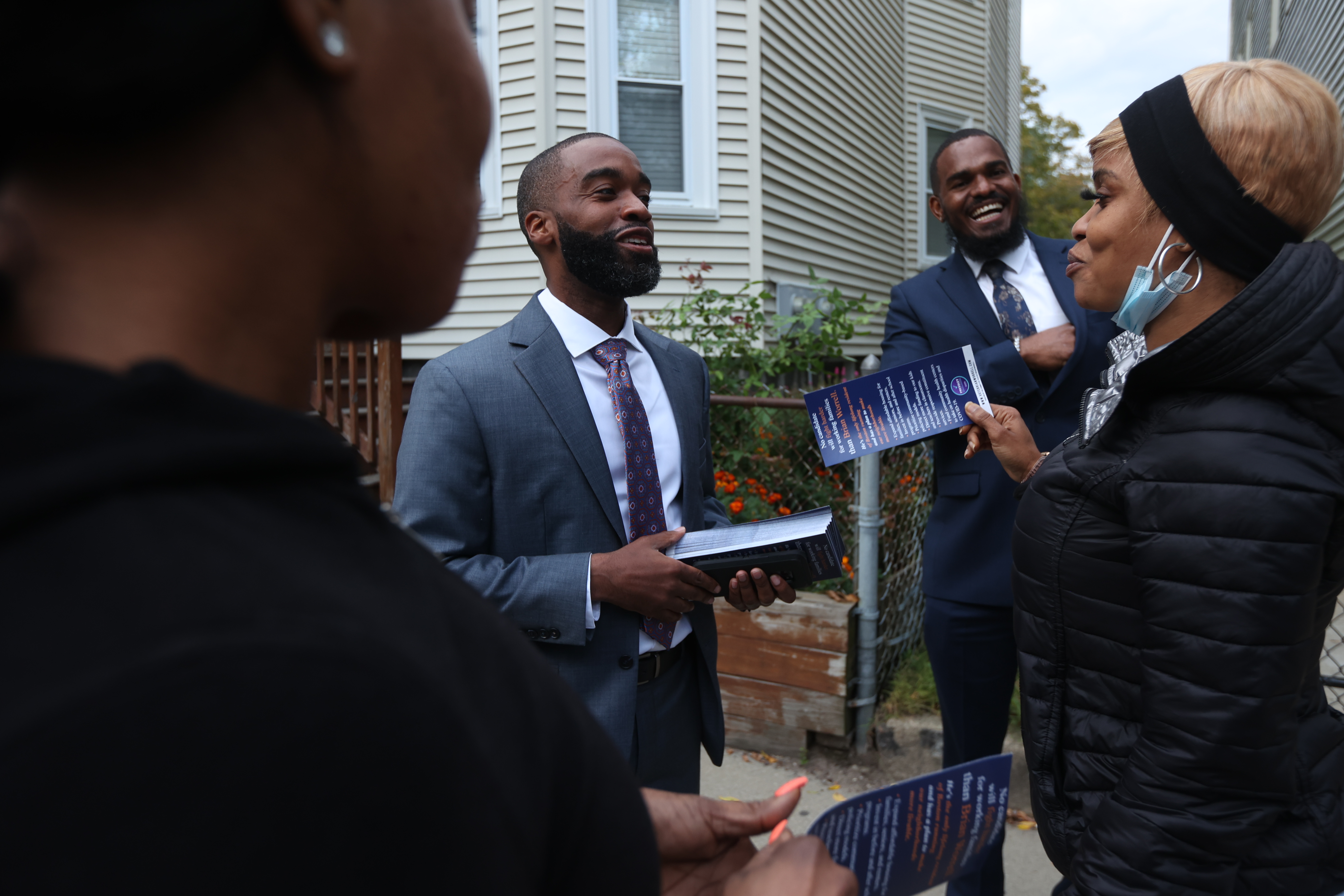 Brian Worrell speaks with Shirieny Pinnock (right) while canvassing with campaign aide Chet Brown (second from right.)