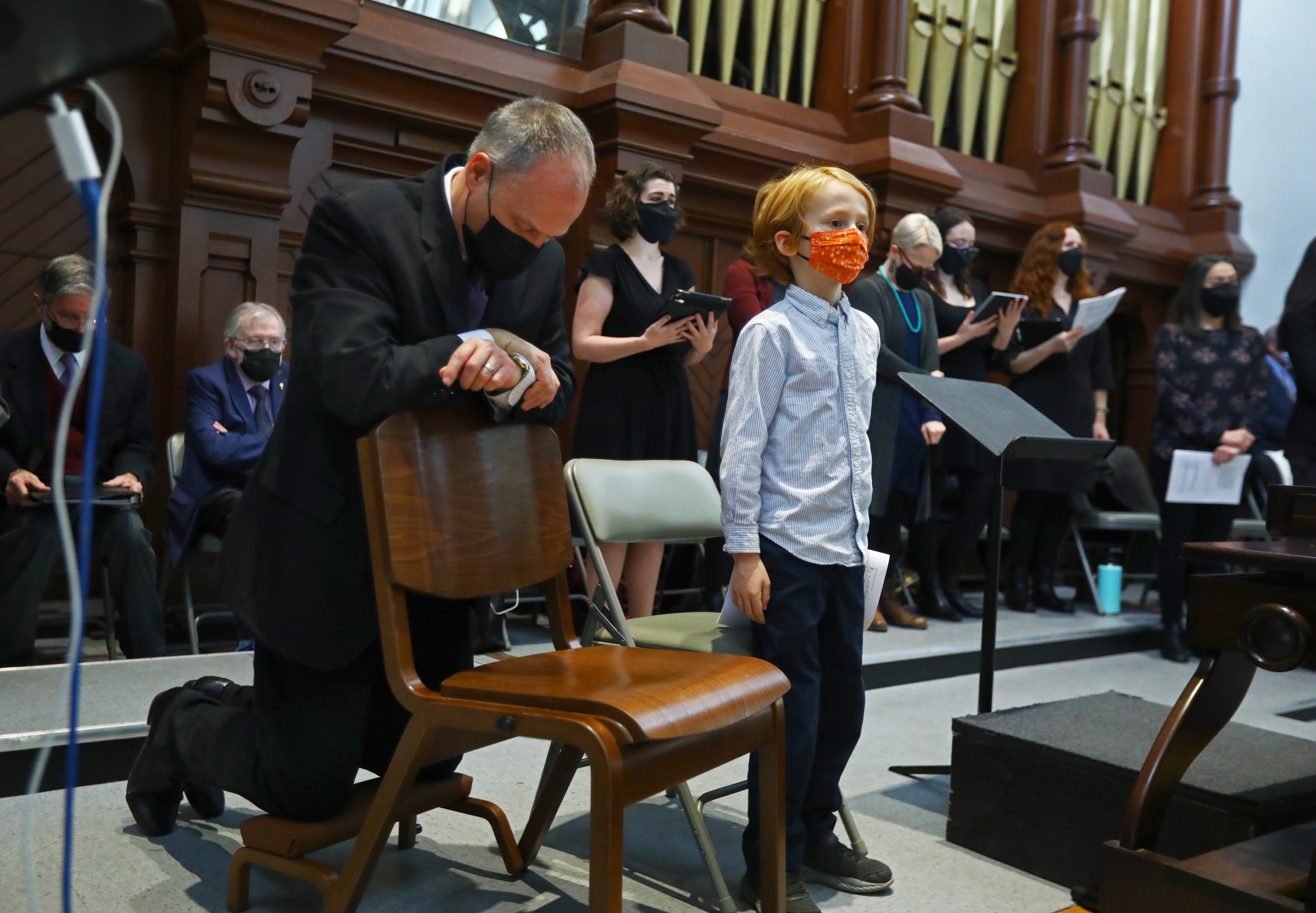 Richard Clark knelt while preparing for Holy Communion with his 7 year old son Sean Clark by his side.