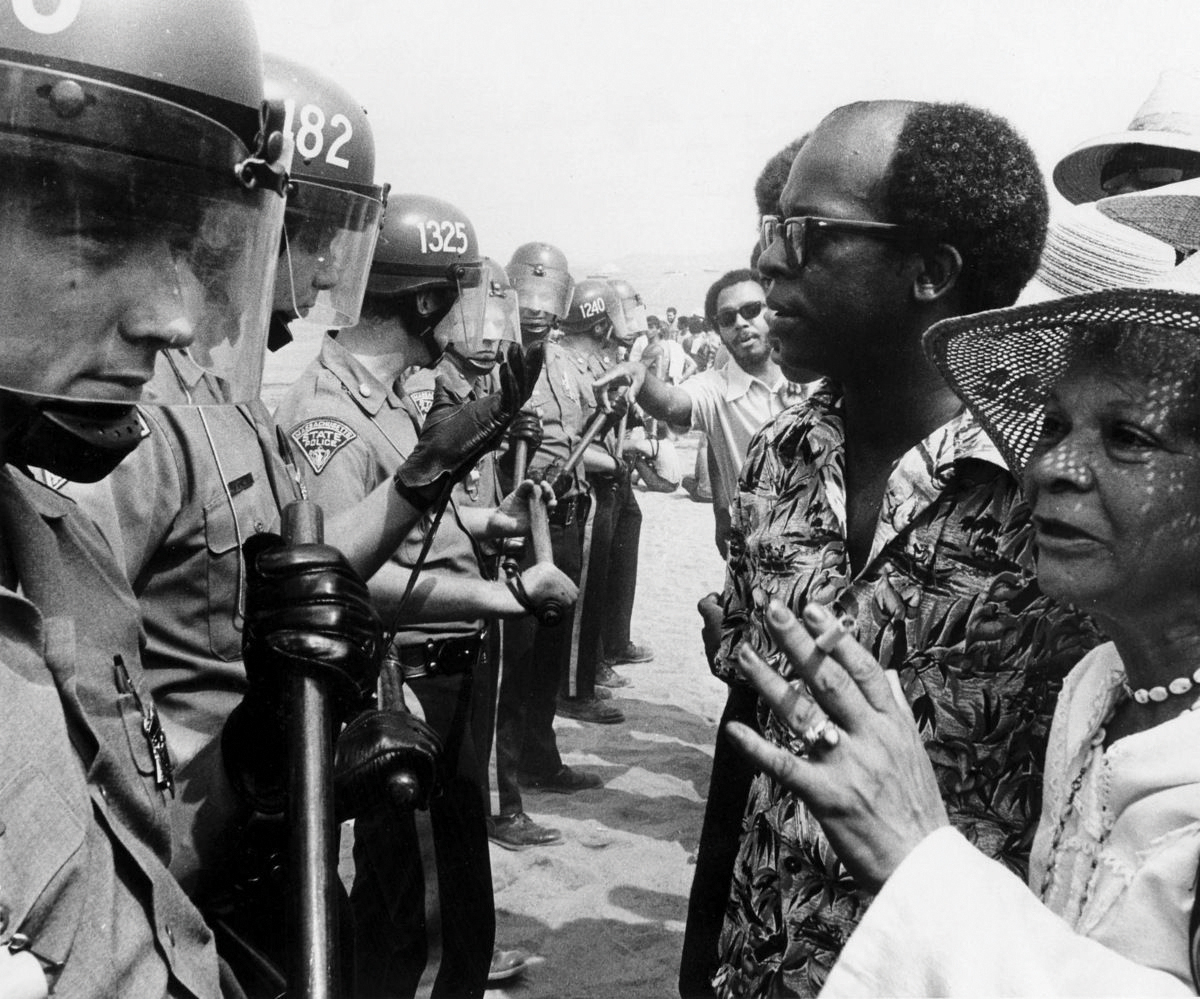 Thomas Atkins, president of the Boston NAACP, speaks with police officers.