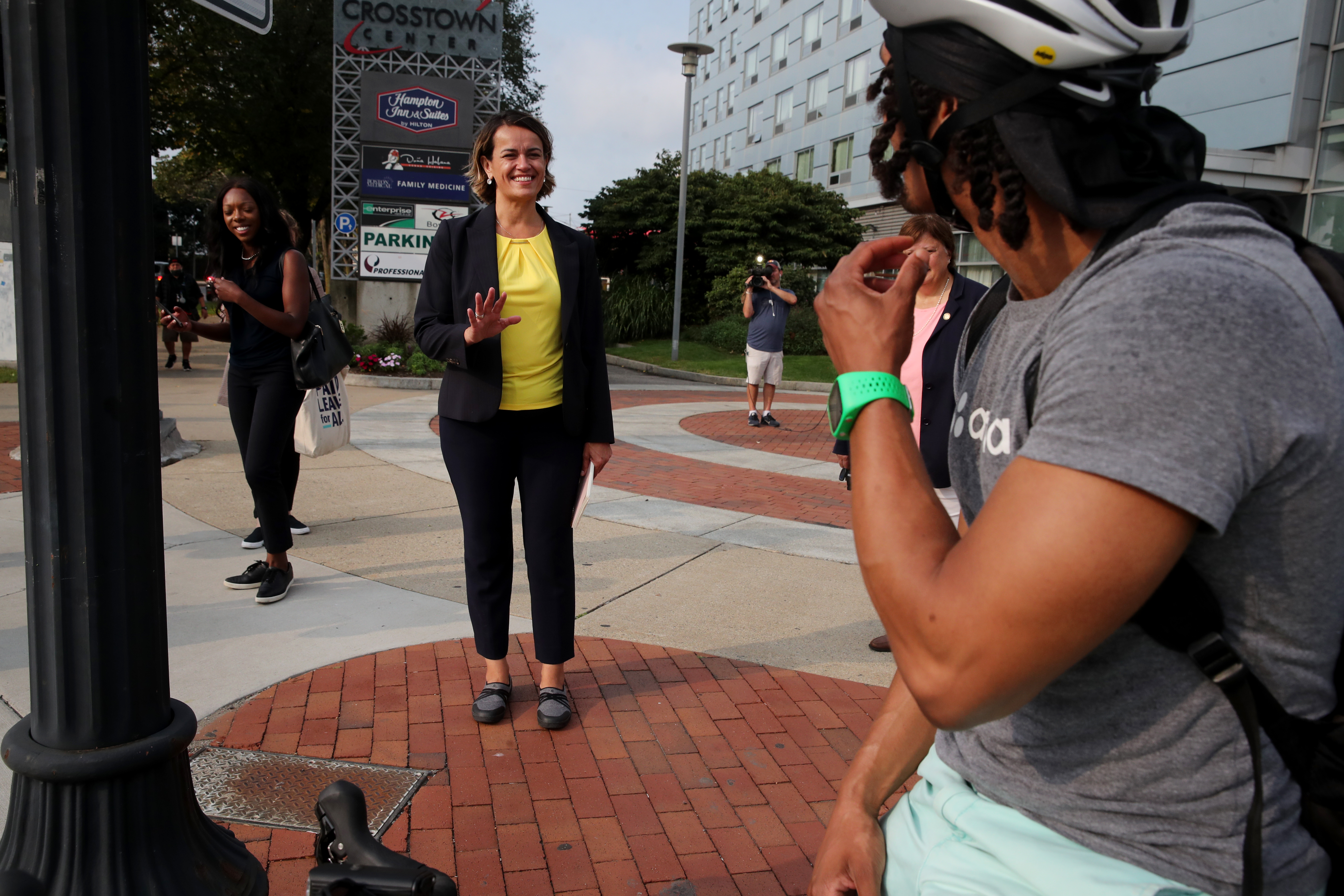 Annissa Essaibi George, City Councilor At-Large and candidate for mayor, greeted a cyclist while touring the area known as Mass. and Cass in Boston on Wednesday.