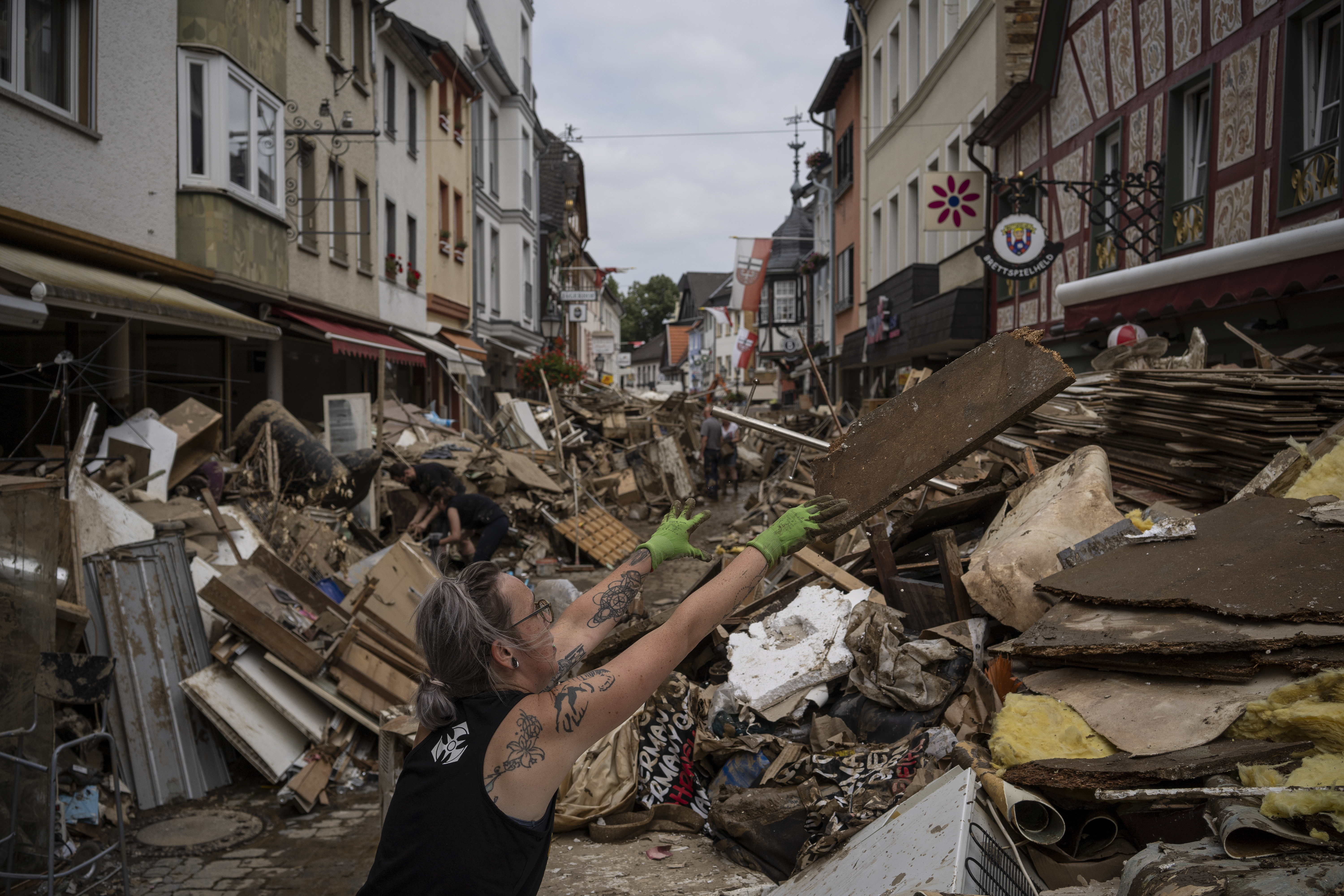 A woman threw away rubbish in the center of Bad Neuenahr-Ahrweiler, Germany, on July 19. More than 180 people died when heavy rainfall turned tiny streams into raging torrents across parts of western Germany and Belgium, and officials put the death toll in Ahrweiler county alone at 110.