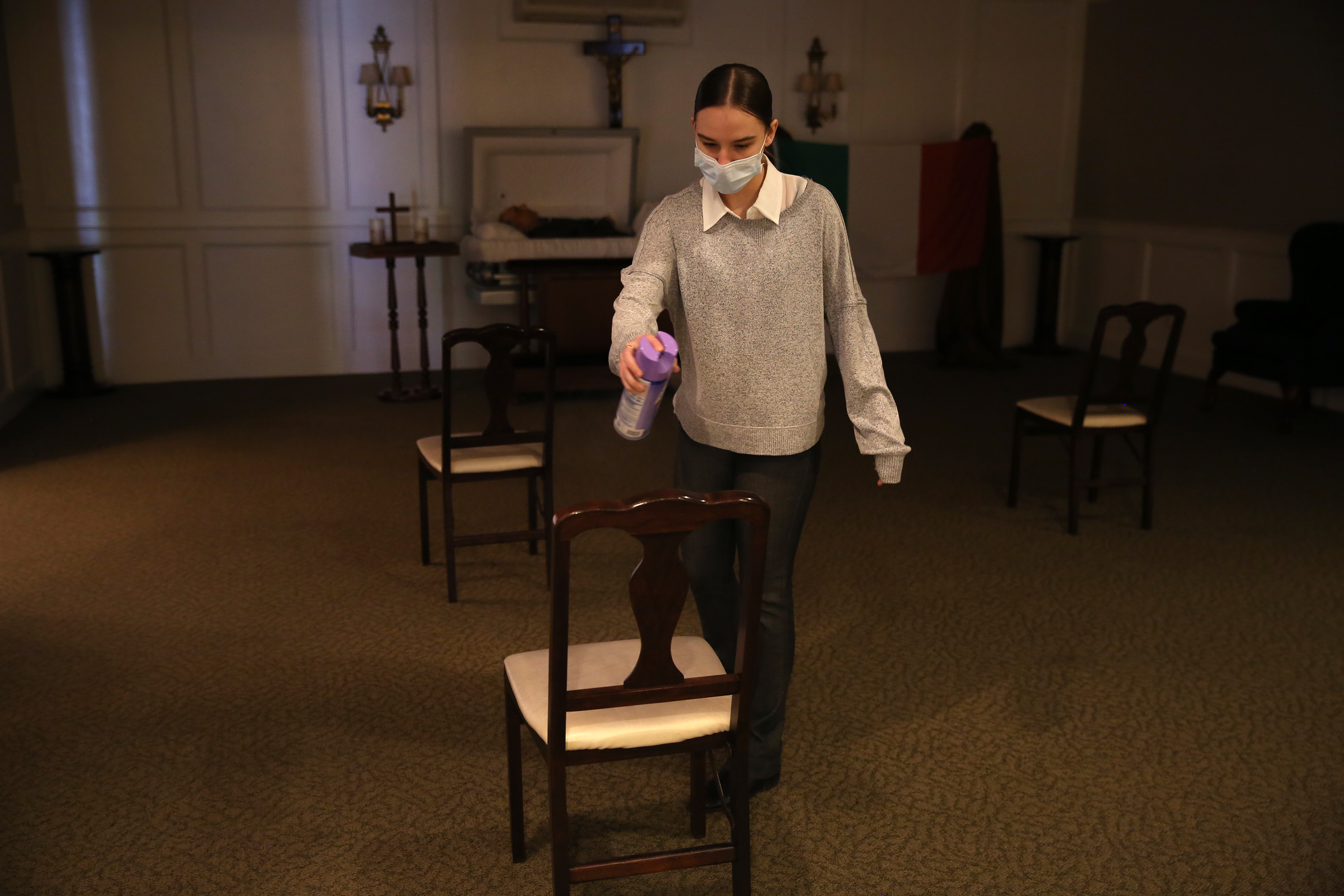 Apprentice funeral director Catie Ruggiero sprayed each chair with Lysol following a wake.