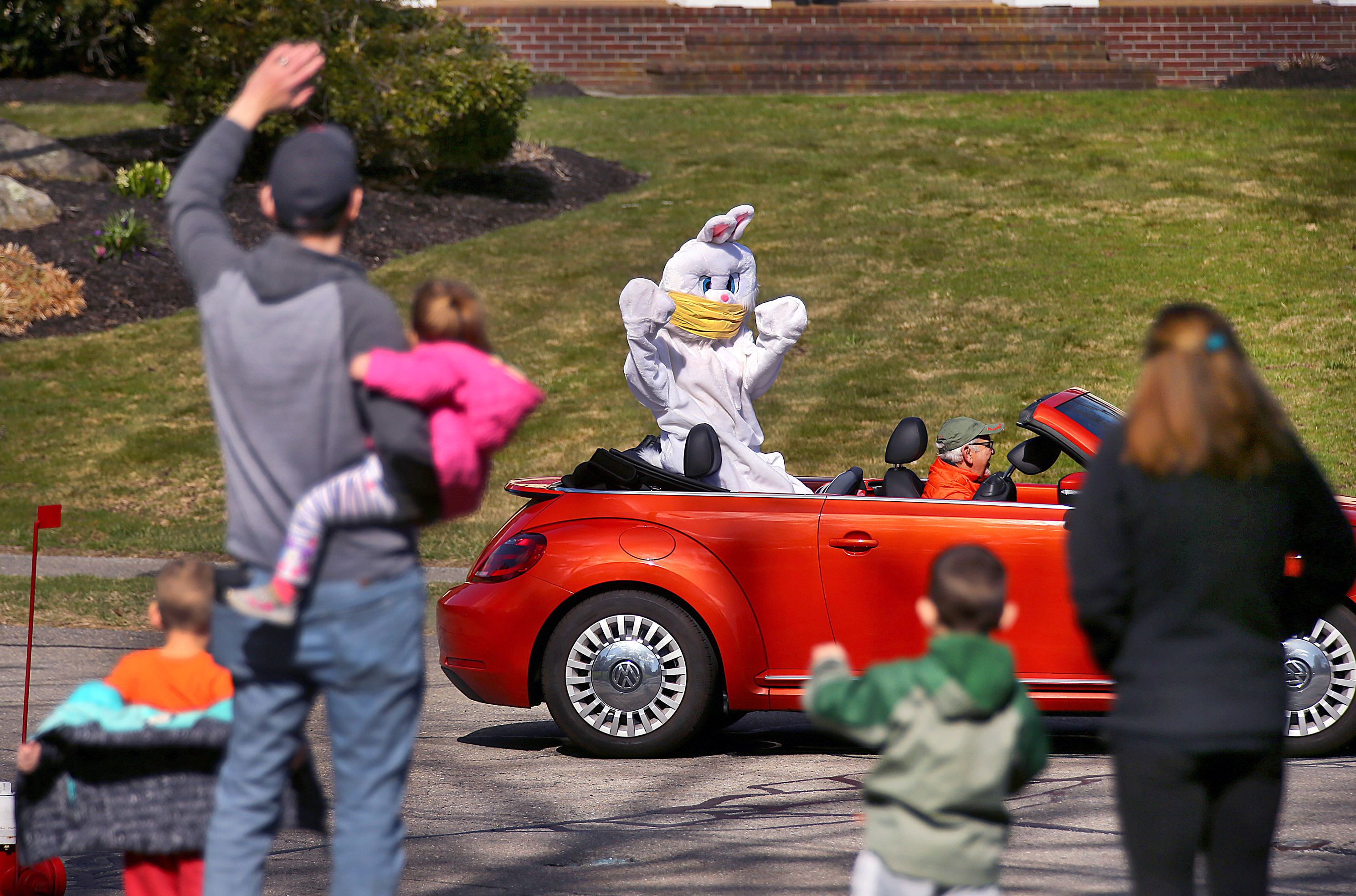 Milford 04/11/2020- The Easter Bunny, aka Francoise Elise was driven around her Milford neighborhood by her husband Mike Guidi to greet children who waited in their yards and front door to see her. Every year, Elise has had a neighborhood Easter Egg hunt and owns the Easter Bunny costume, but this year was impossible because of coronavirus, so she decided to do a 