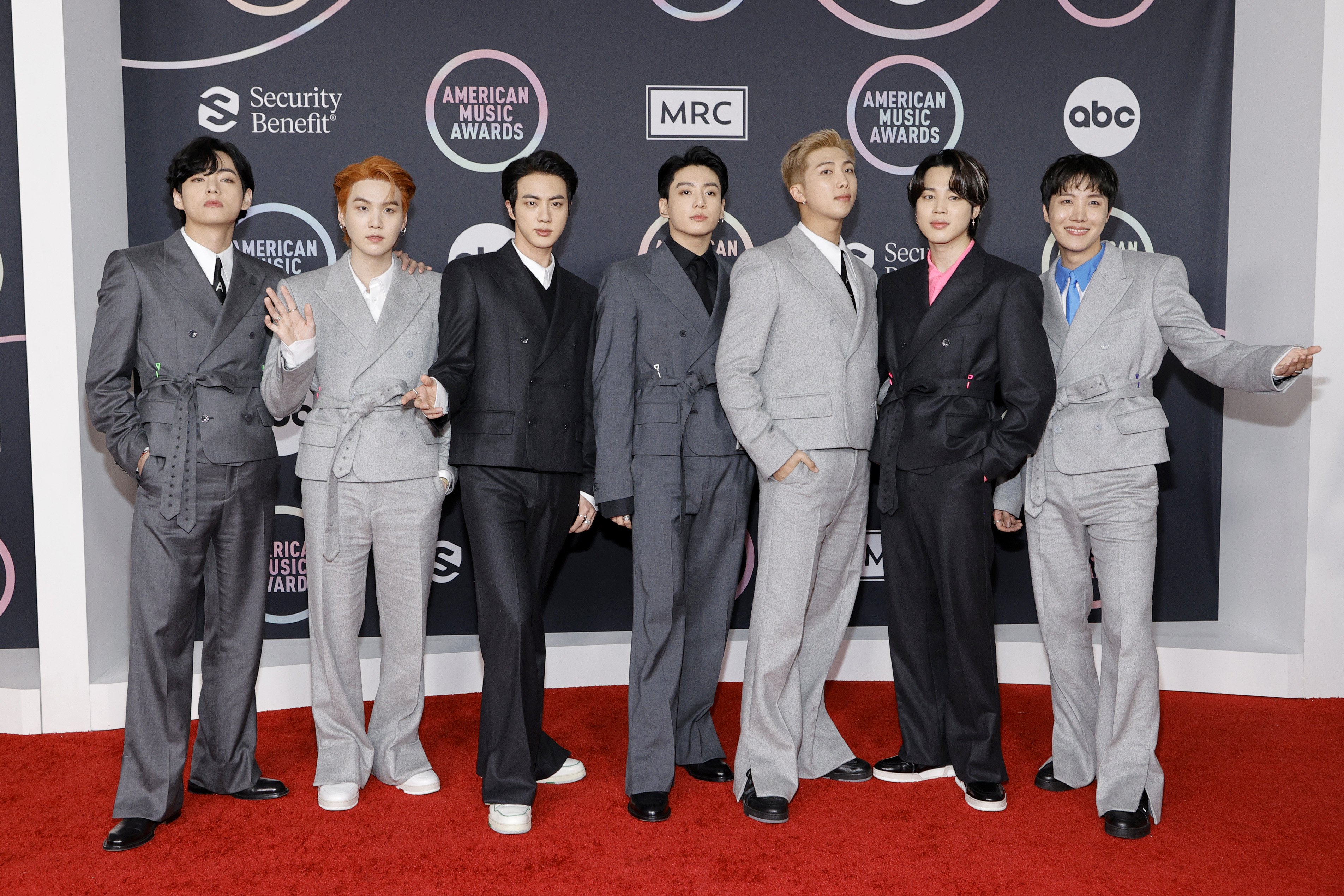 BTS wore Louis Vuitton suits in various shades of black and gray.