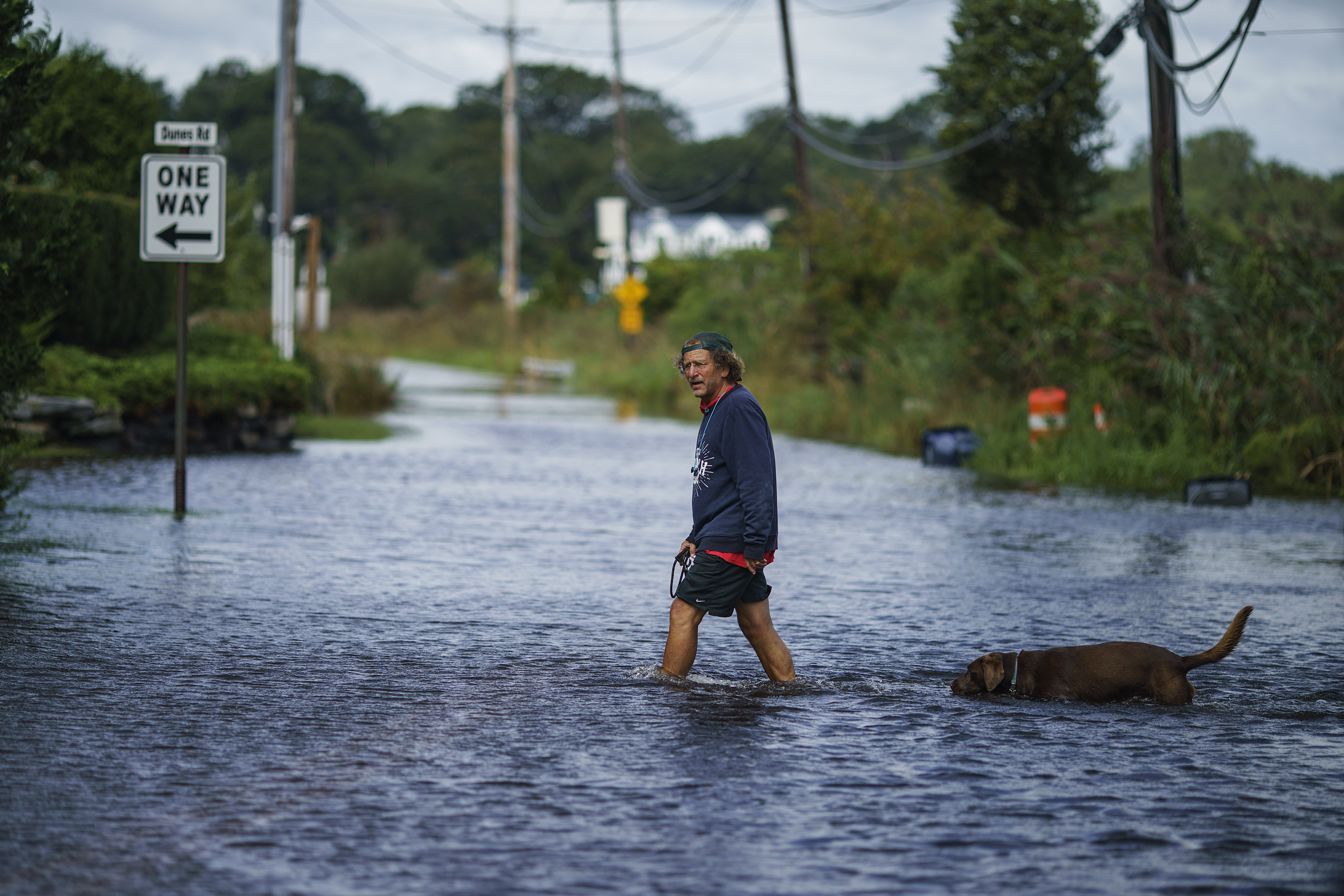 A resident waded through a flooded street in Narragansett, R.I., on Thursday after the remnants of Hurricane Ida passed through the area.