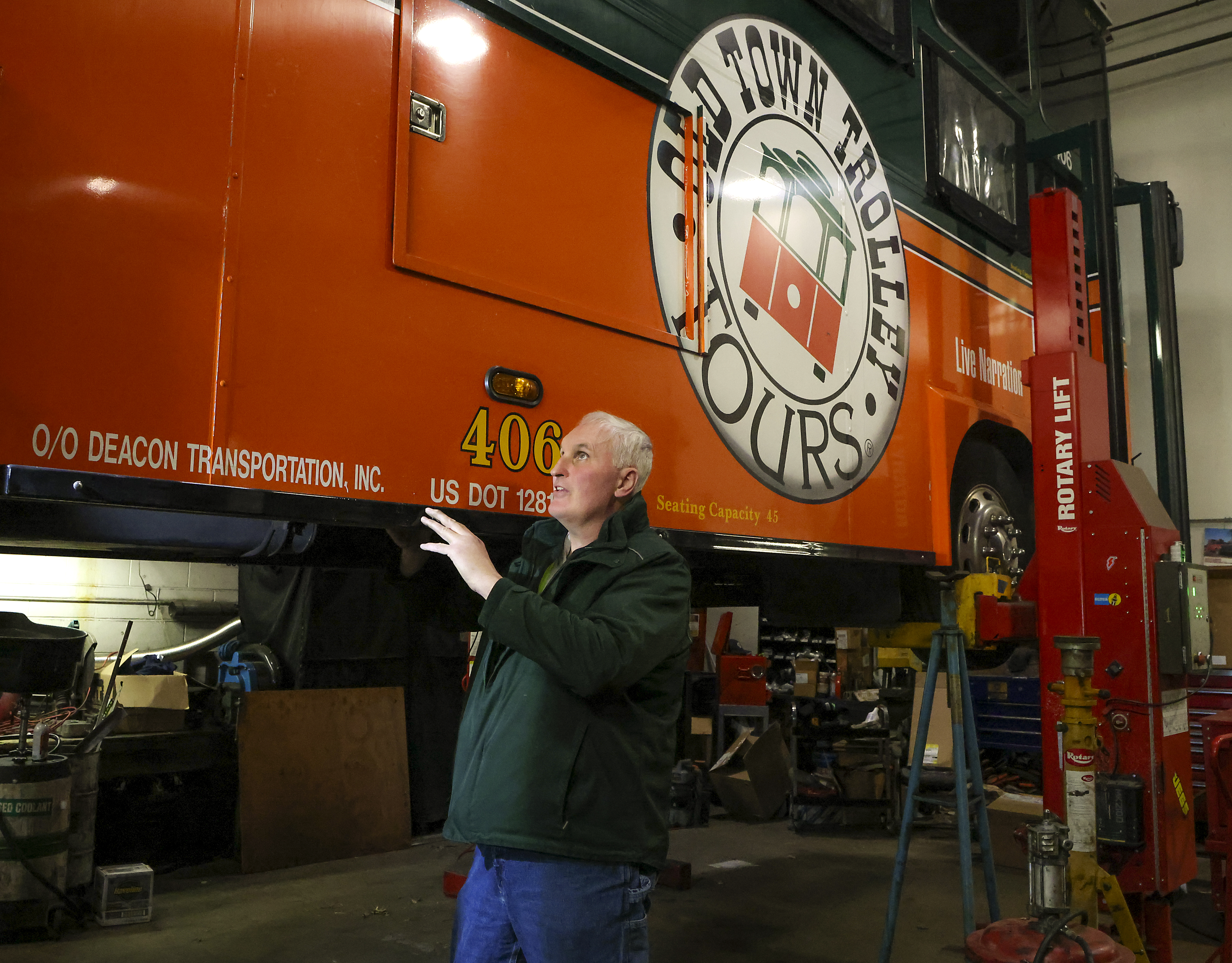 Bob Gibson, the fleet manager of Old Town Trolley Tours, lined up a floor jack on a trolley in preparation for the spring tourism season.