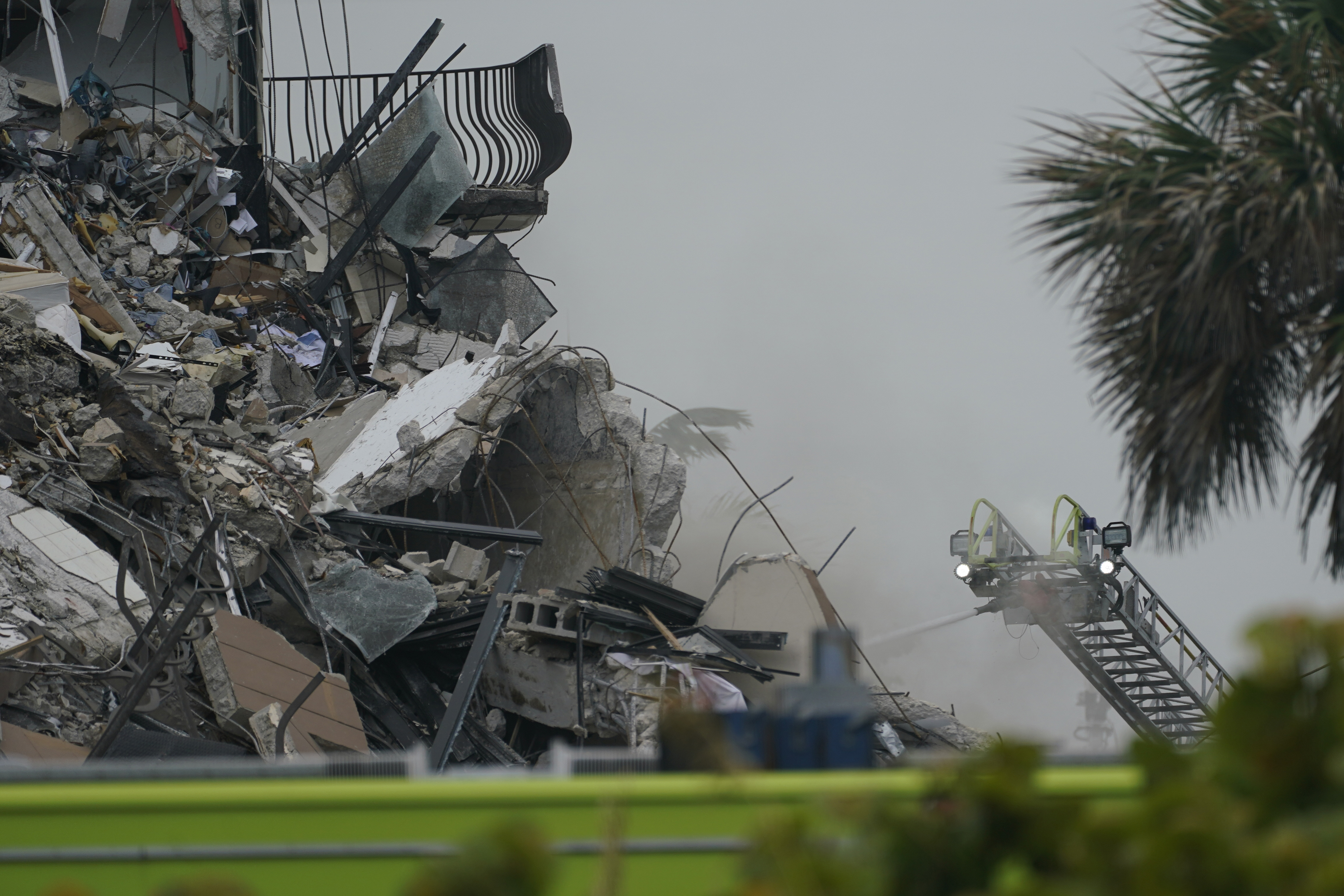 Firefighters used a ladder hose as smoke came out of the rubble.
