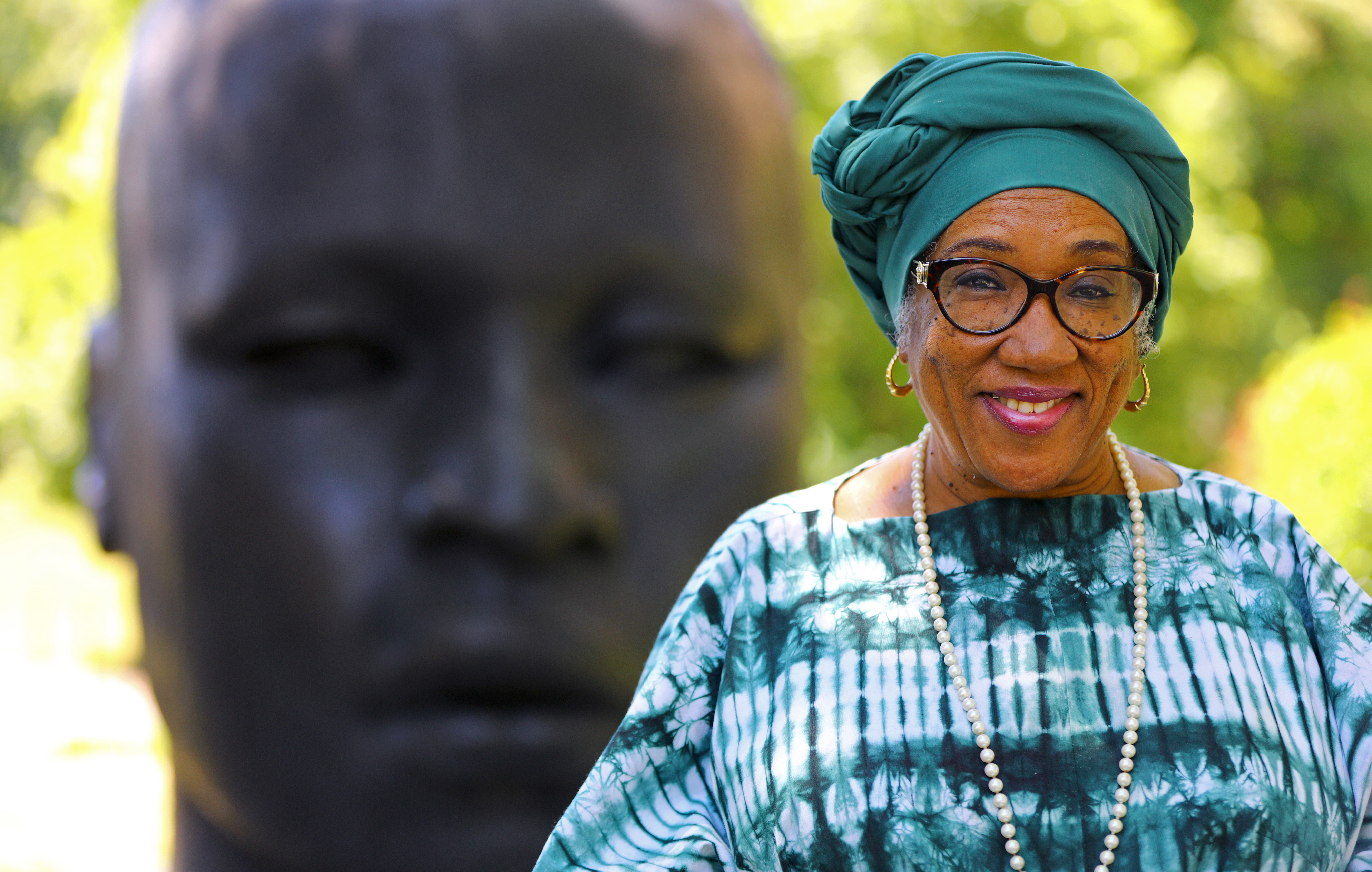 Jumaada A-K. Henry Smith is the chairwoman of the Boston Juneteenth Committee. She is photographed outside the National Center of Afro-American Artists, near the "Eternal Presence, 1987" sculpture, by artist John Wilson.