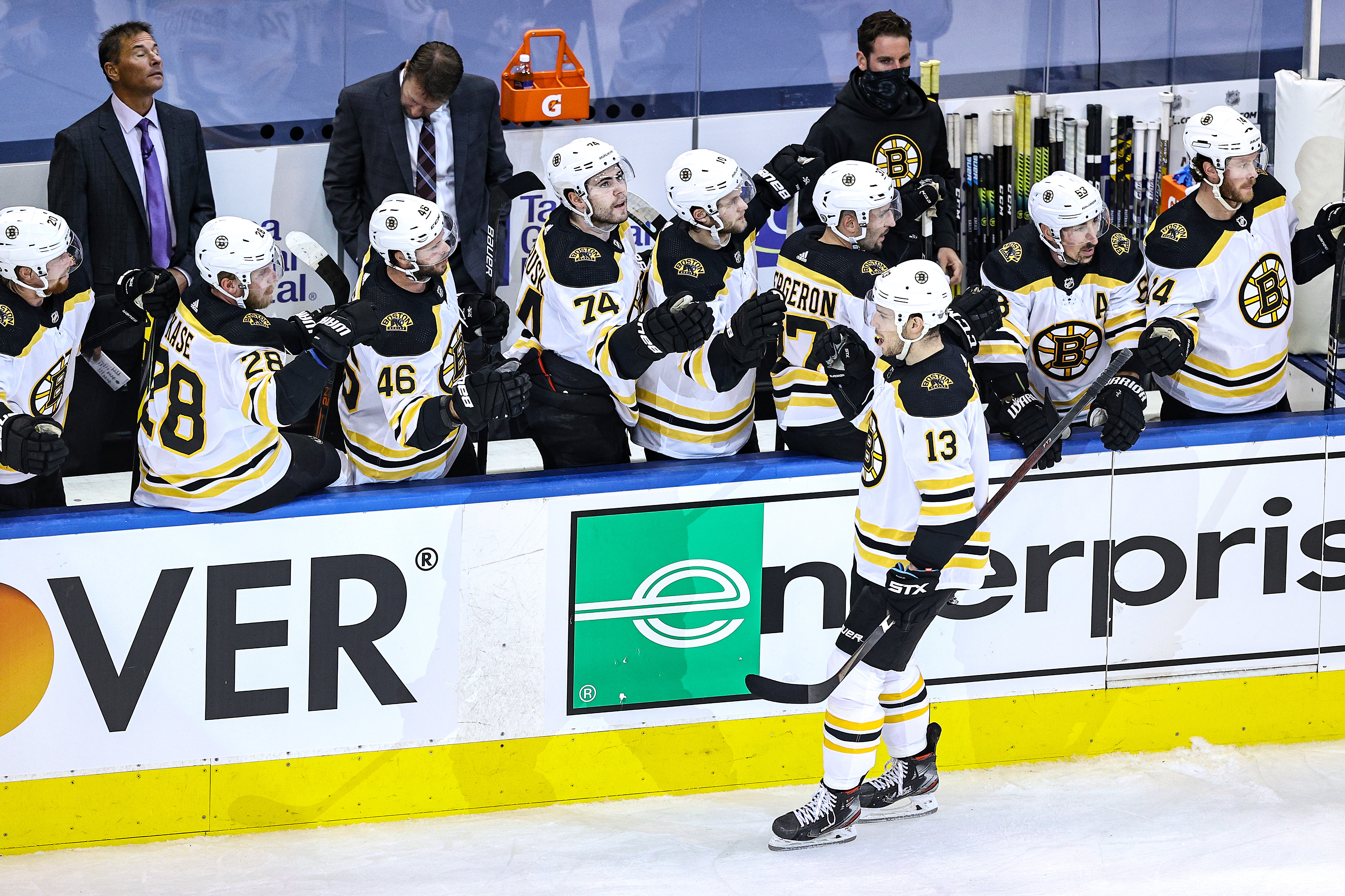 Charlie Coyle is congratulated by his teammates after scoring a first-period goal against Tampa Bay Sunday night.