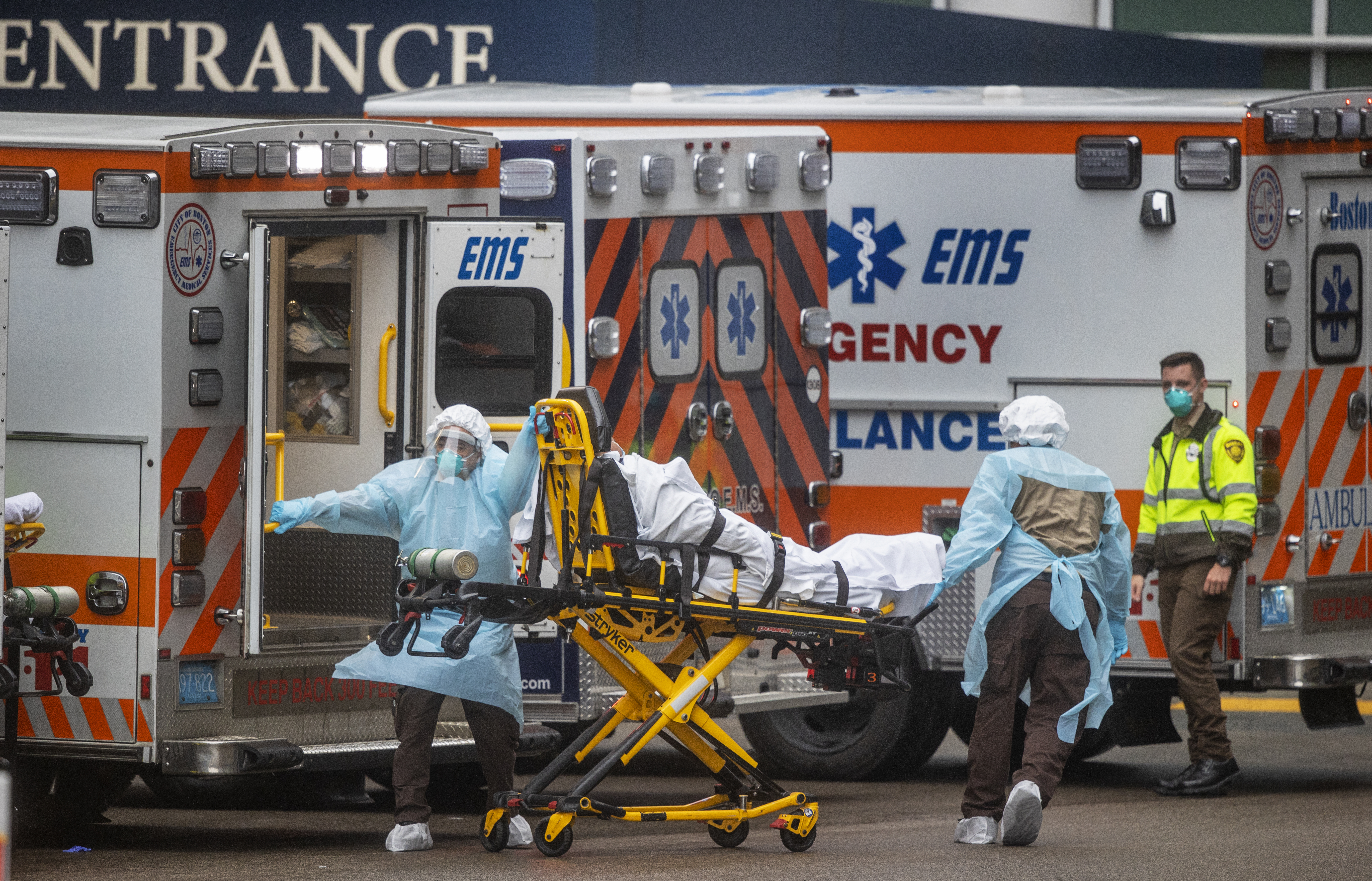 Boston, Mass-March 29, 2020: EMT’s rush a patient to the emergency room at Mass General Hospital during the coronavirus emergency. (Stan Grossfeld/Globe Staff)