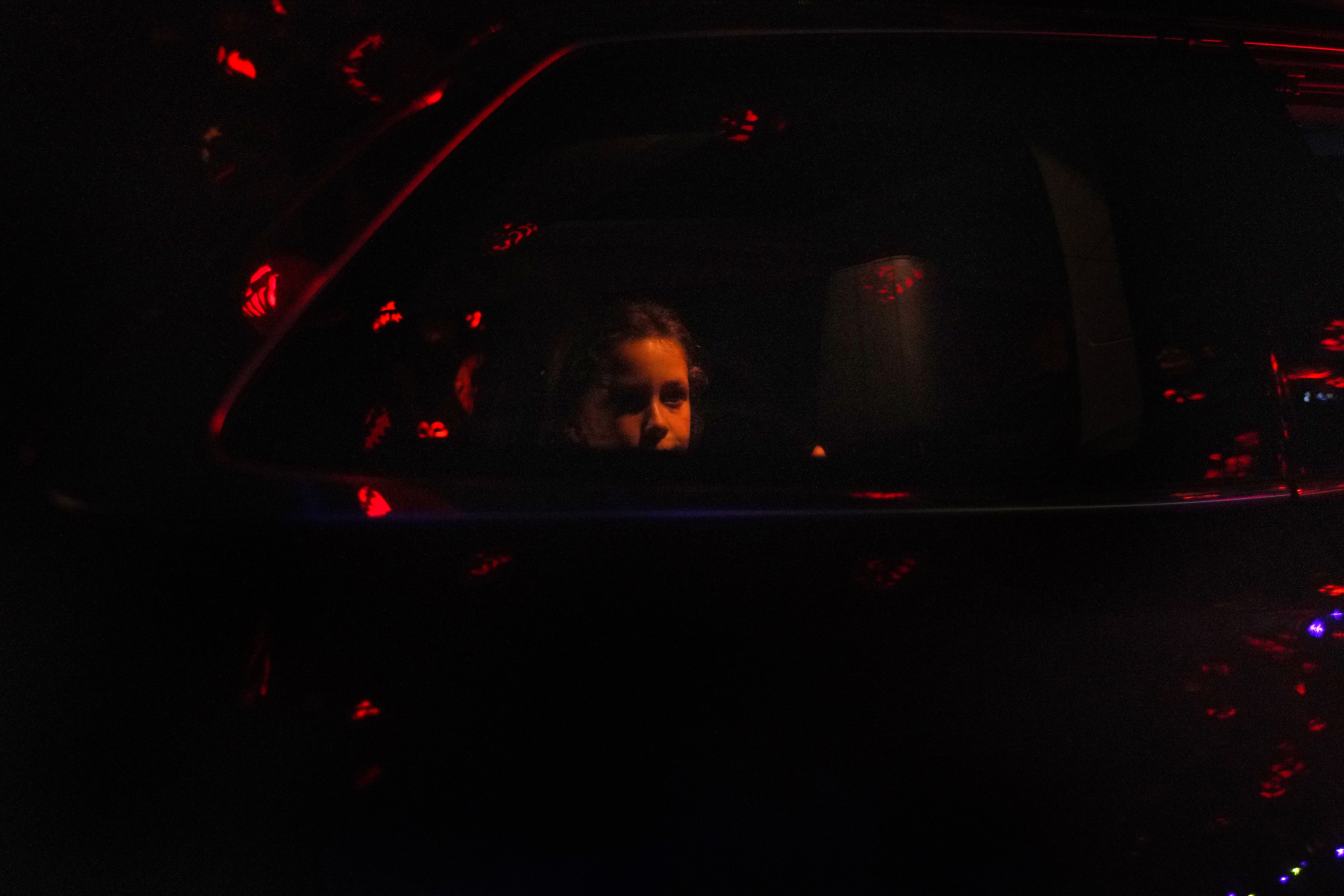 Spectators take in the scene during drive-through-only viewing of the annual Jack-o'-Lantern Spectacular at Roger Williams Park Zoo.