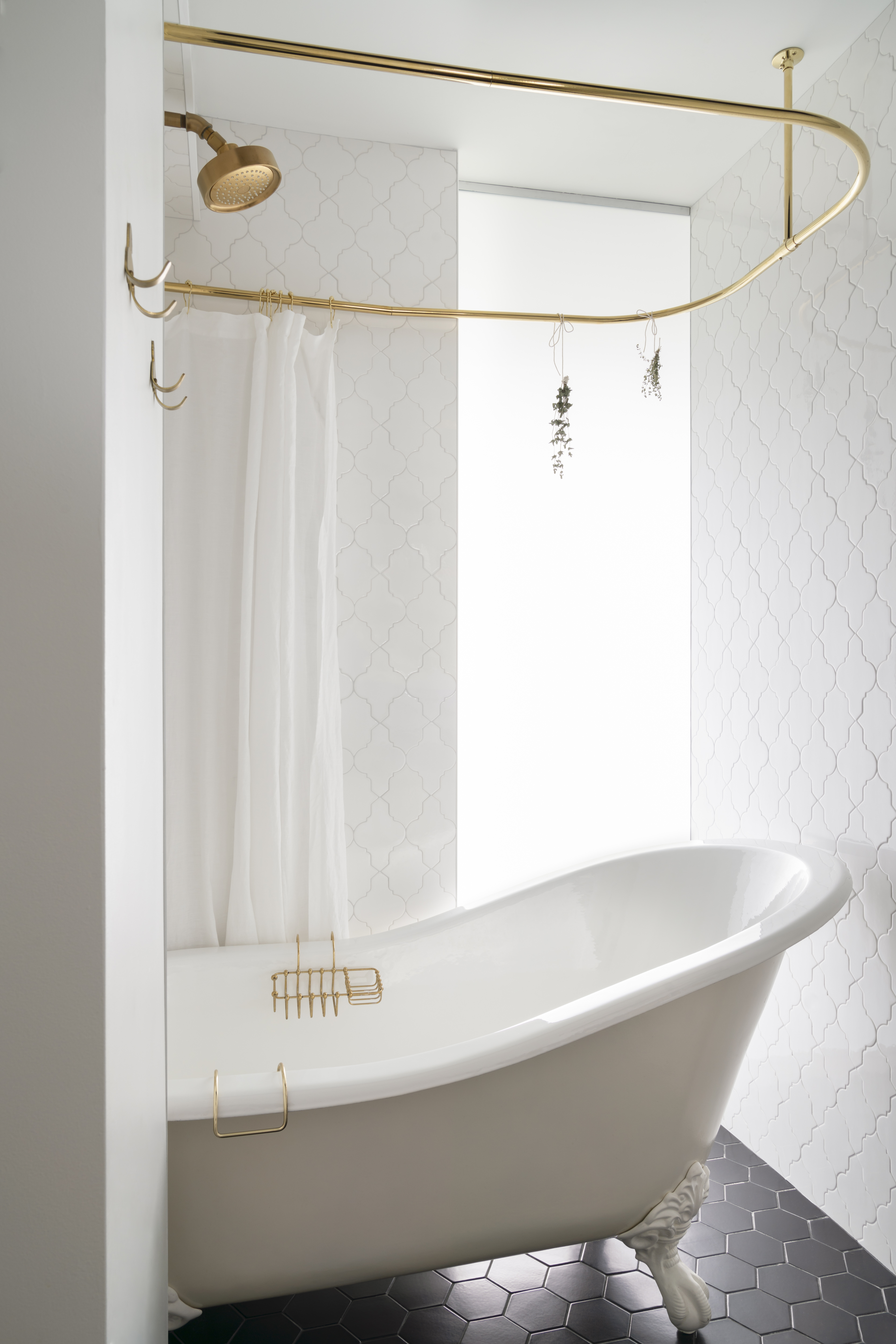 Privacy glass in the guest bath goes from frosted to clear at the flick of a switch to offer a view out the windows in the dining area.