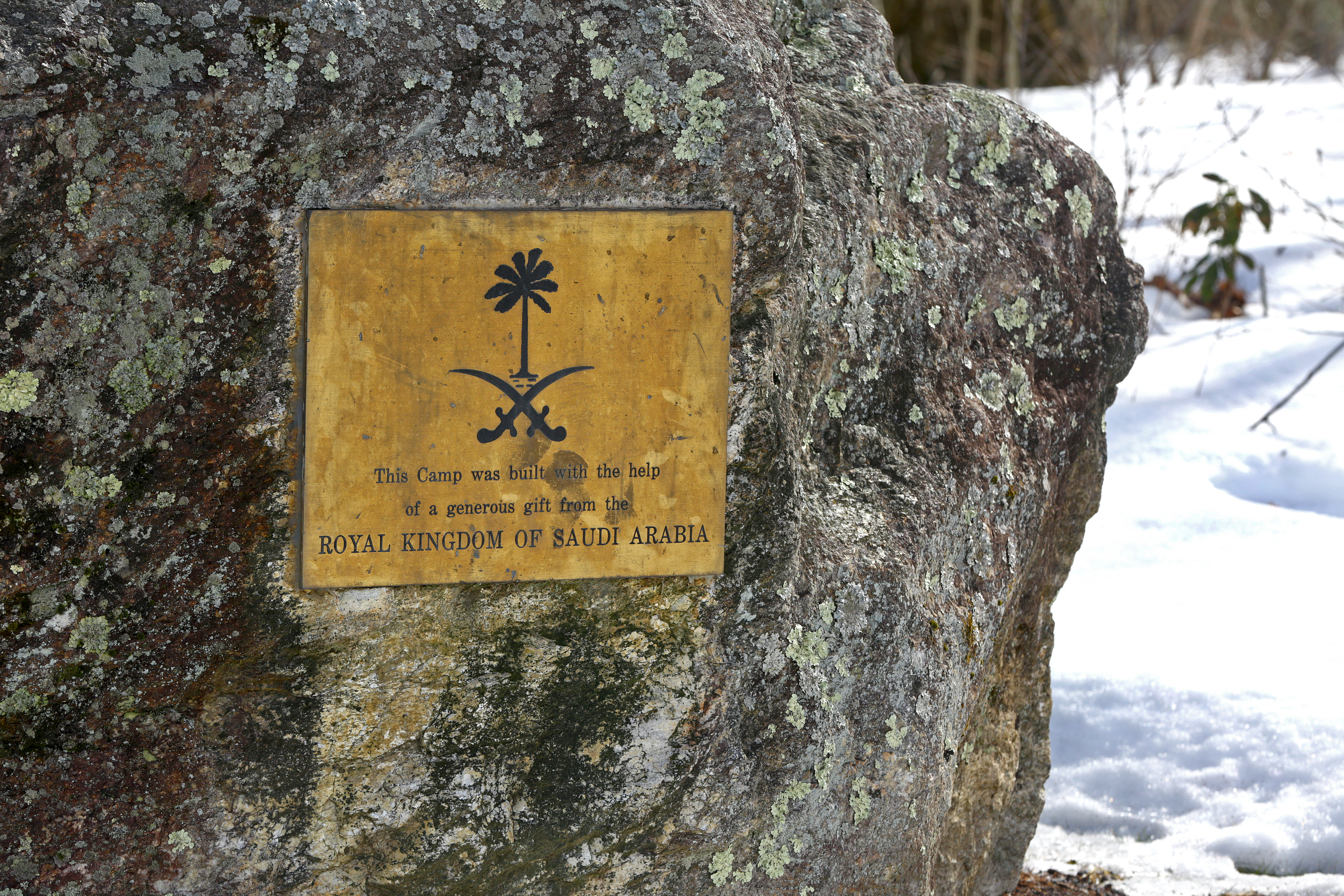 A plaque adorns a rock near the buildings, at Paul Newman's Hole in the Wall Gang Camp, in Ashford, Conn., that were recently destroyed by fire.